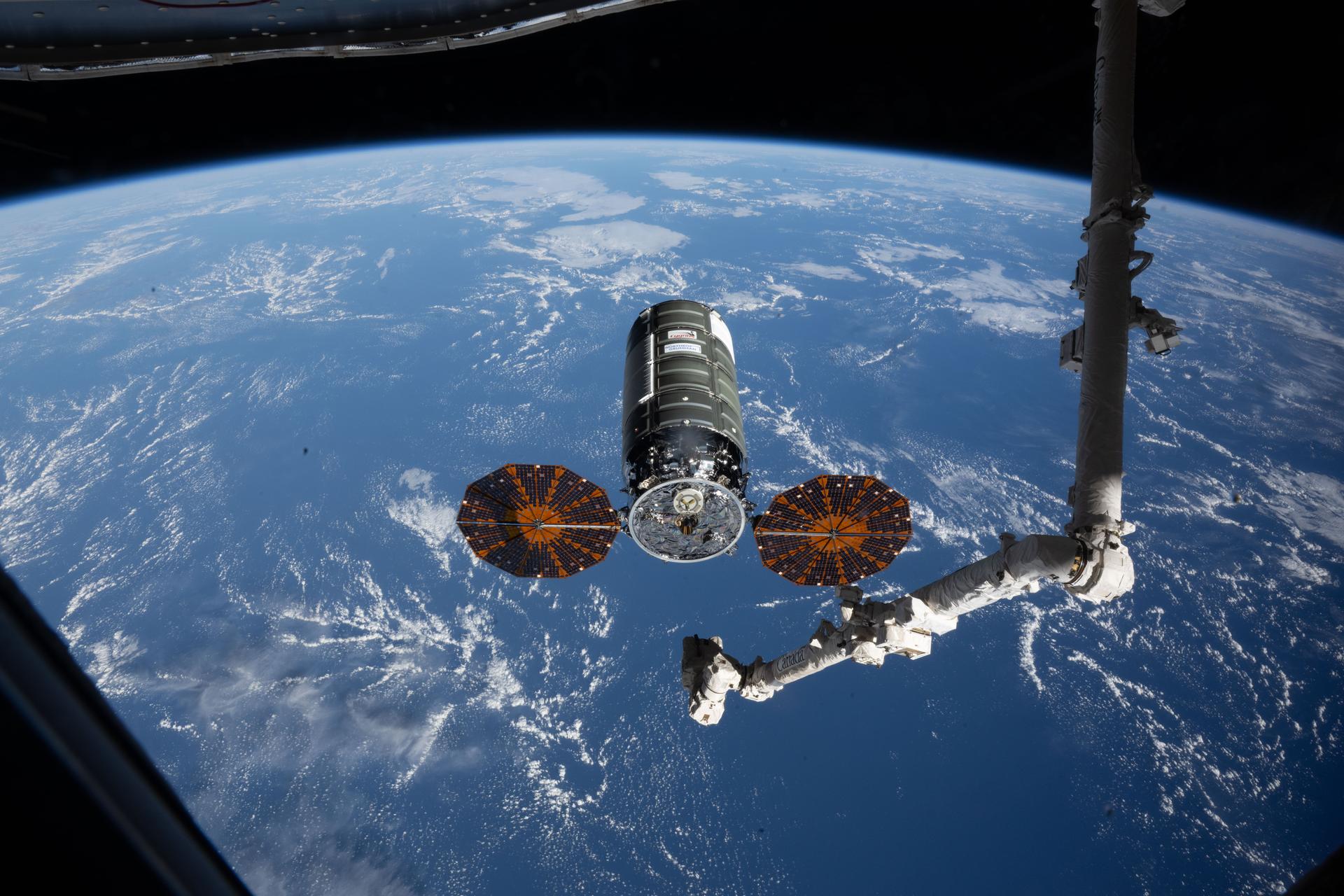 iss074e0458241 (April 13, 2026) --- Northrop Grumman's Cygnus XL cargo spacecraft rests at its capture point, 12 meters from the International Space Station, as the Canadarm2 robotic arm prepares to grapple the resupply ship. Cygnus XL delivered more than 11,000 pounds of new science experiments, lab hardware, and crew supplies for the Expedition 74 crew. Credit: NASA/Jessica Meir