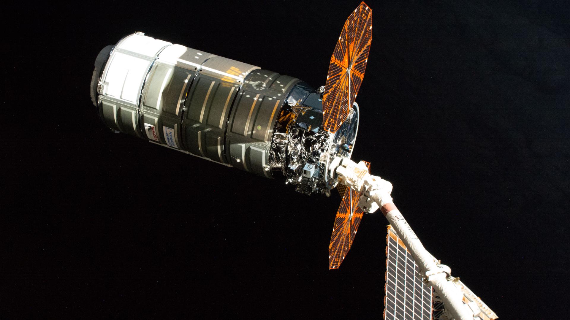 iss074e0458279 (April 13, 2026) --- Northrop Grumman's Cygnus XL cargo spacecraft, carrying over 11,000 pounds of new science experiments, lab hardware, and crew supplies, is pictured in the grips of the Canadarm2 robotic arm following its capture at the International Space Station. Credit: NASA
