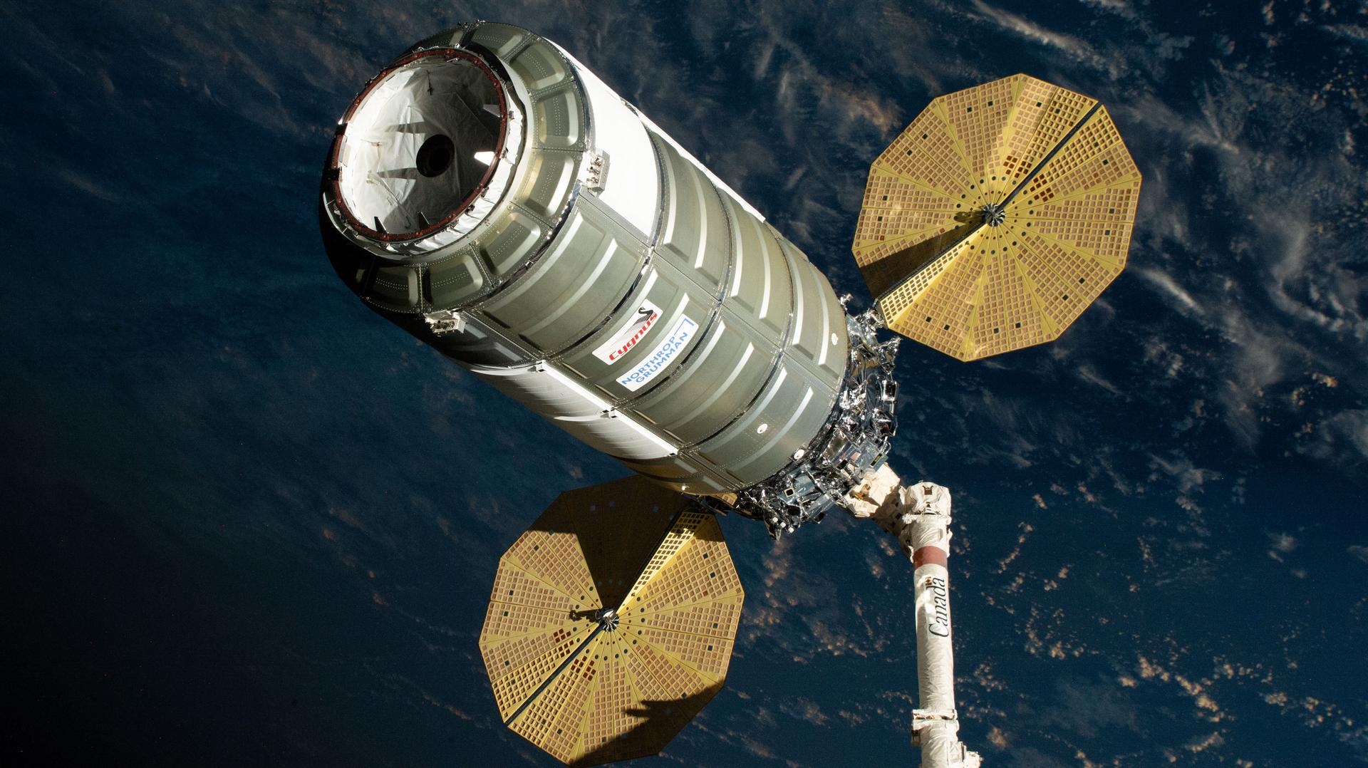 iss074e0459132 (April 13, 2026) --- Northrop Grumman's Cygnus XL cargo spacecraft is held in the grips of the Canadarm2 robotic arm as it is maneuvered toward the International Space Station’s Unity module for installation. Cygnus XL delivered more than 11,000 pounds of new science experiments, lab hardware, and crew supplies for the Expedition 74 crew. Credit: NASA/Jessica Meir
