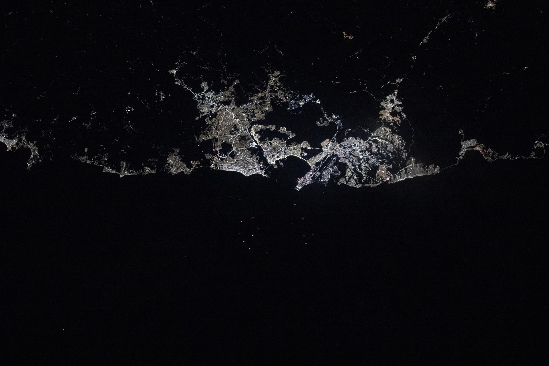 Vitoria, Brazil, with a metropolitan population of about 1.8 million, lights up the eastern Atlantic coast of the South American nation in this photograph taken at 3:59 a.m. local time from the International Space Station as it orbited 262 miles above.