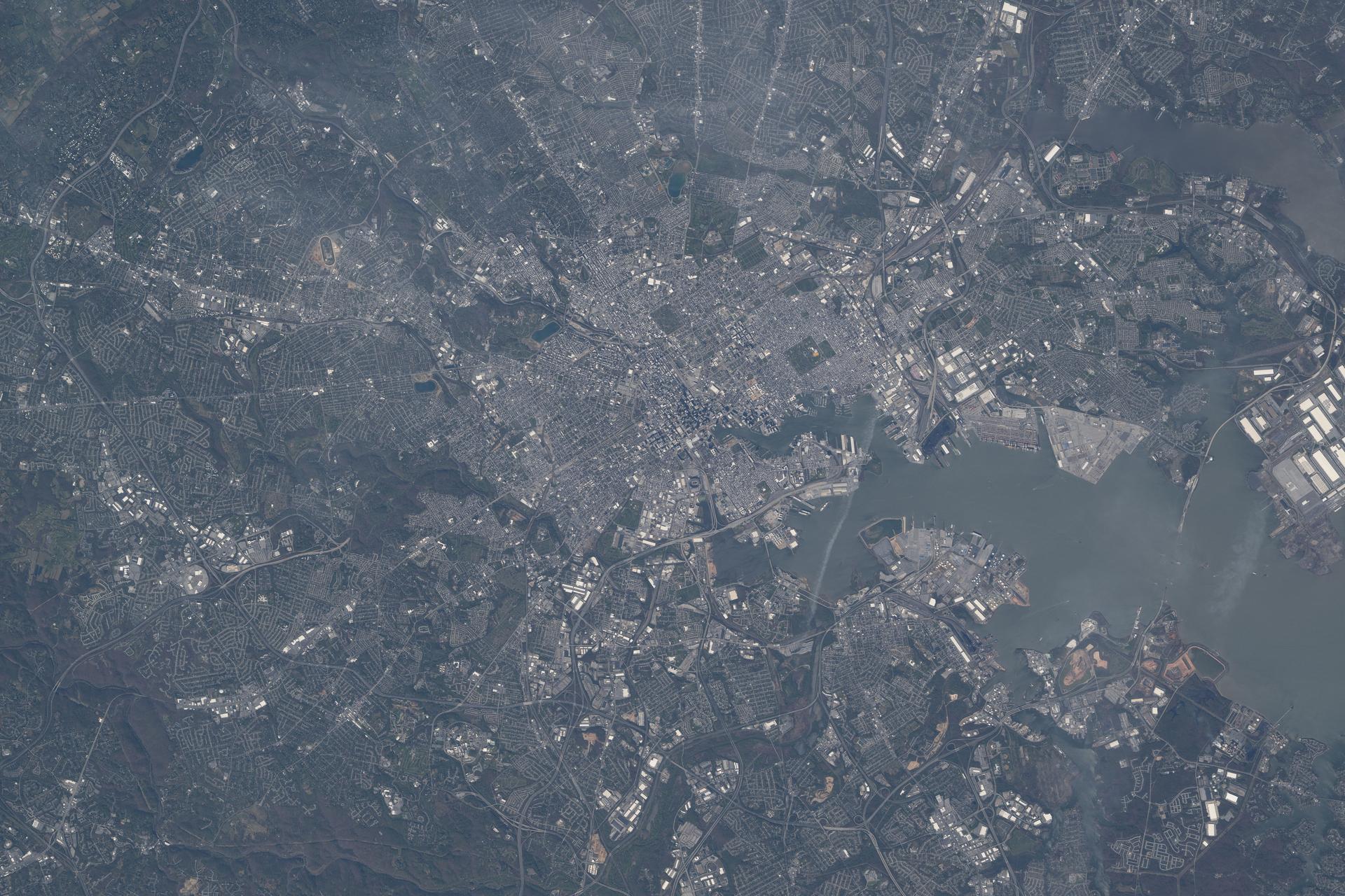 iss074e0459538 (April 10, 2026) --- Baltimore, Maryland, on the Patapsco River with a metropolitan population of about 2.86 million and birthplace of baseball legend Babe Ruth, is pictured from the International Space Station as it orbited 266 miles above. Credit: NASA/Chris Williams