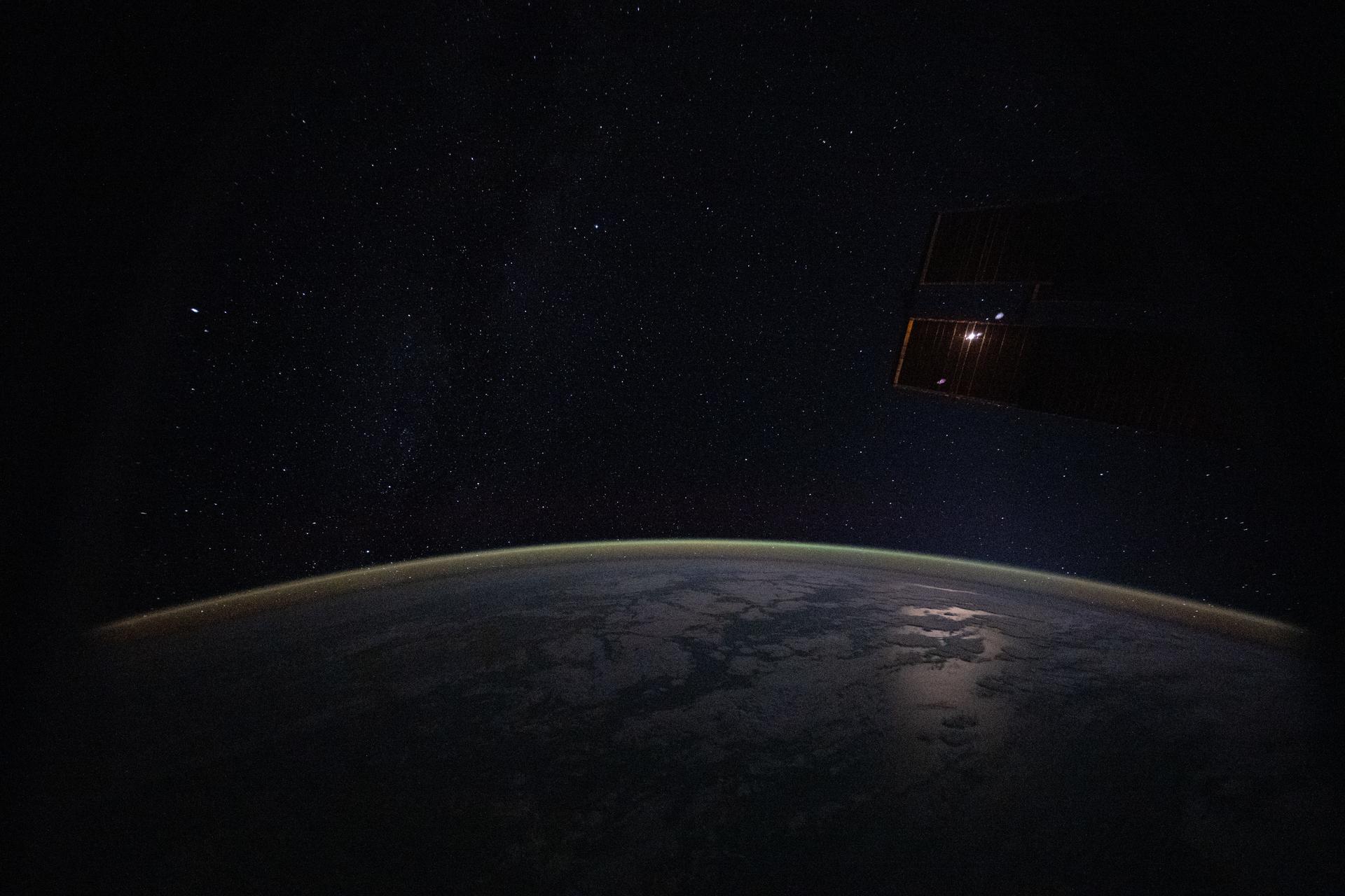 This serene image, taken from the International Space Station as it orbited 265 miles above the Indian Ocean, highlights a yellow‑green airglow blanketing Earth’s atmosphere beneath a starry sky at approximately 2:37 a.m. local time.