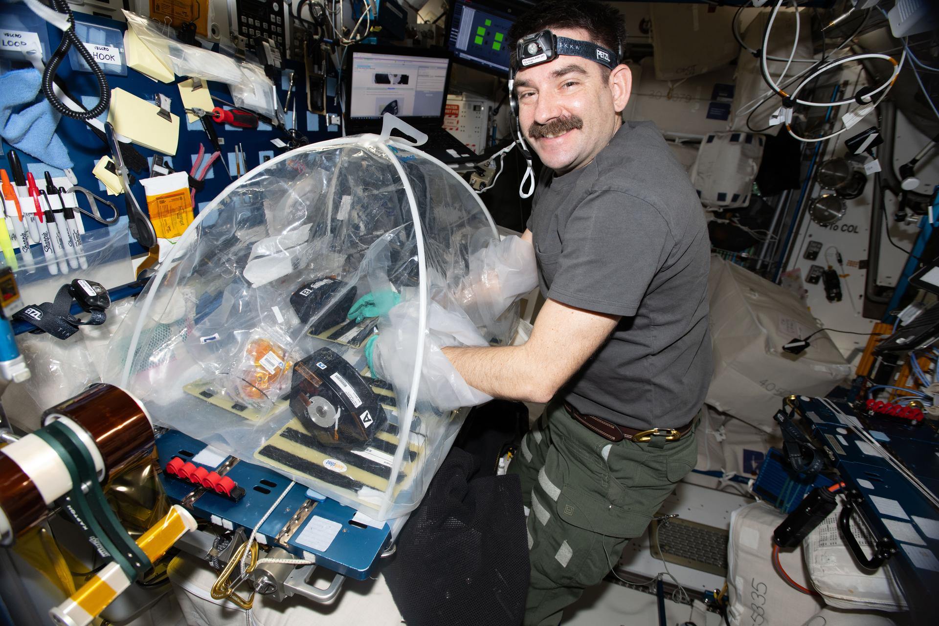 iss074e0490731 (April 16, 2026) --- NASA astronaut and Expedition 74 flight engineer Jack Hathaway configures research hardware inside a portable glovebag for a biotechnology investigation exploring how bacteria affect heart tissue in the microgravity environment. Results from the MVP (Multi-use Variable-g Platform) Cell-09 experiment could lead to advanced methods for preventing or treating heart damage in humans living on and off the Earth. Credit: ESA/Sophie Adenot