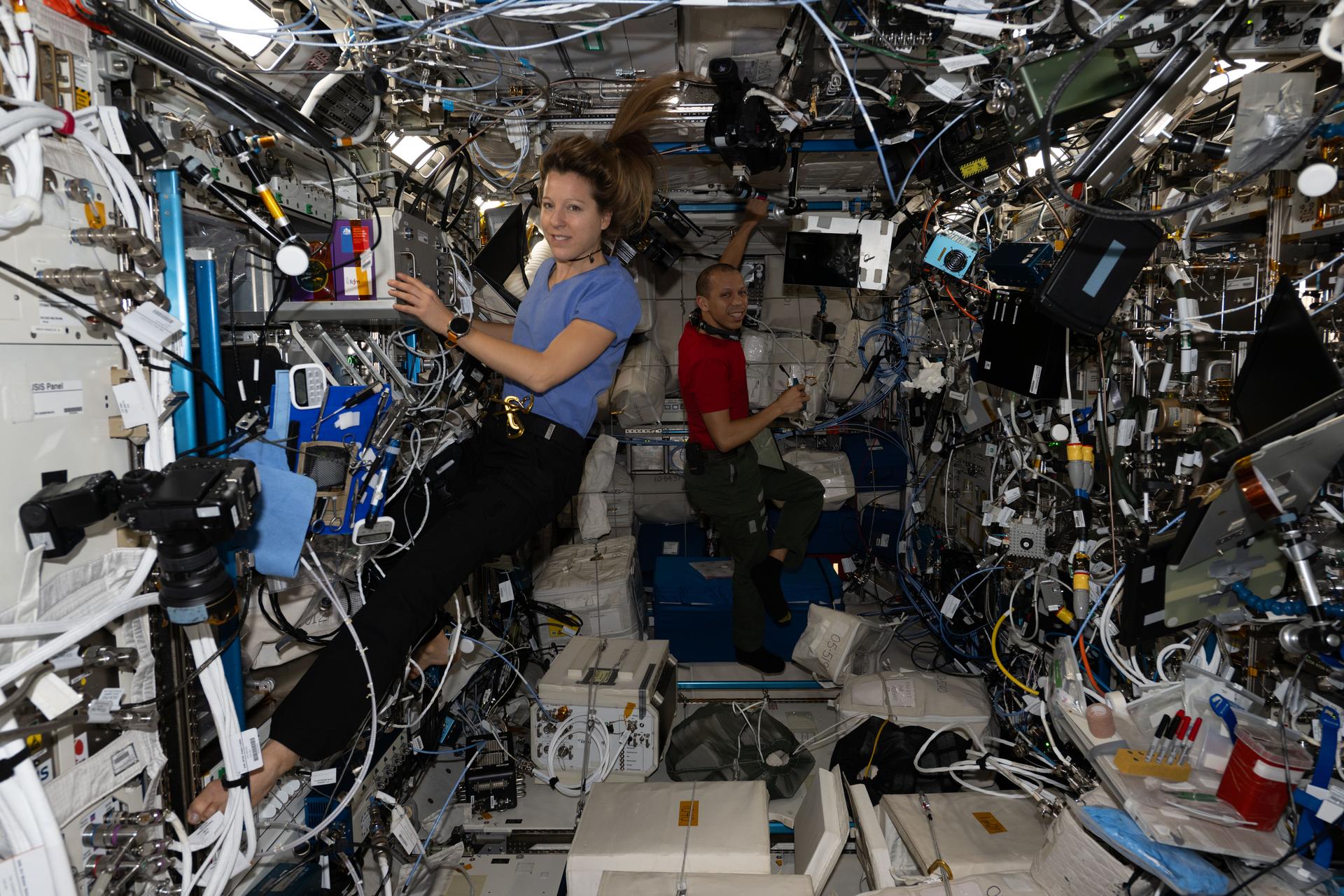 Expedition 74 flight engineers Sophie Adenot of ESA (European Space Agency) and Chris Williams of NASA work together inside the International Space Station’s Columbus laboratory module to install and activate new research gear delivered on Northrop Grumman’s second Cygnus XL cargo mission. Williams was configuring the new European Enhanced Exploration Exercise Device, while Adenot was installing advanced biotechnology experiment hardware.
