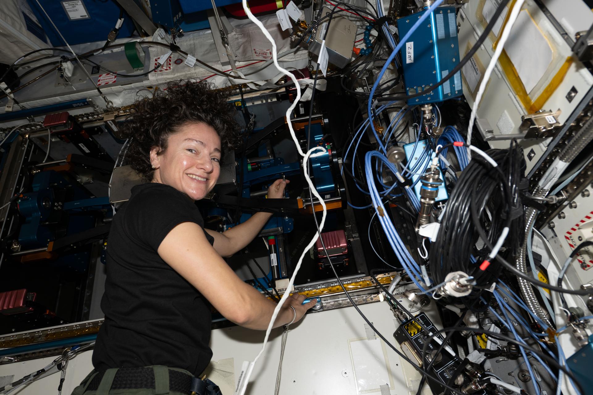 iss074e0490818 (April 15, 2026) --- NASA astronaut and Expedition 74 flight engineer Jessica Meir works inside the International Space Station's Columbus laboratory module replacing components on the new European Enhanced Exploration Exercise Device, or E4D, to ensure its accurate motion, alignment, and system longevity. The E4D was delivered on Northrop Grumman's second Cygnus XL cargo mission and will be evaluated for its ability to support crew workouts on missions to the Moon, Mars, and beyond. Credit: NASA/Jessica Meir