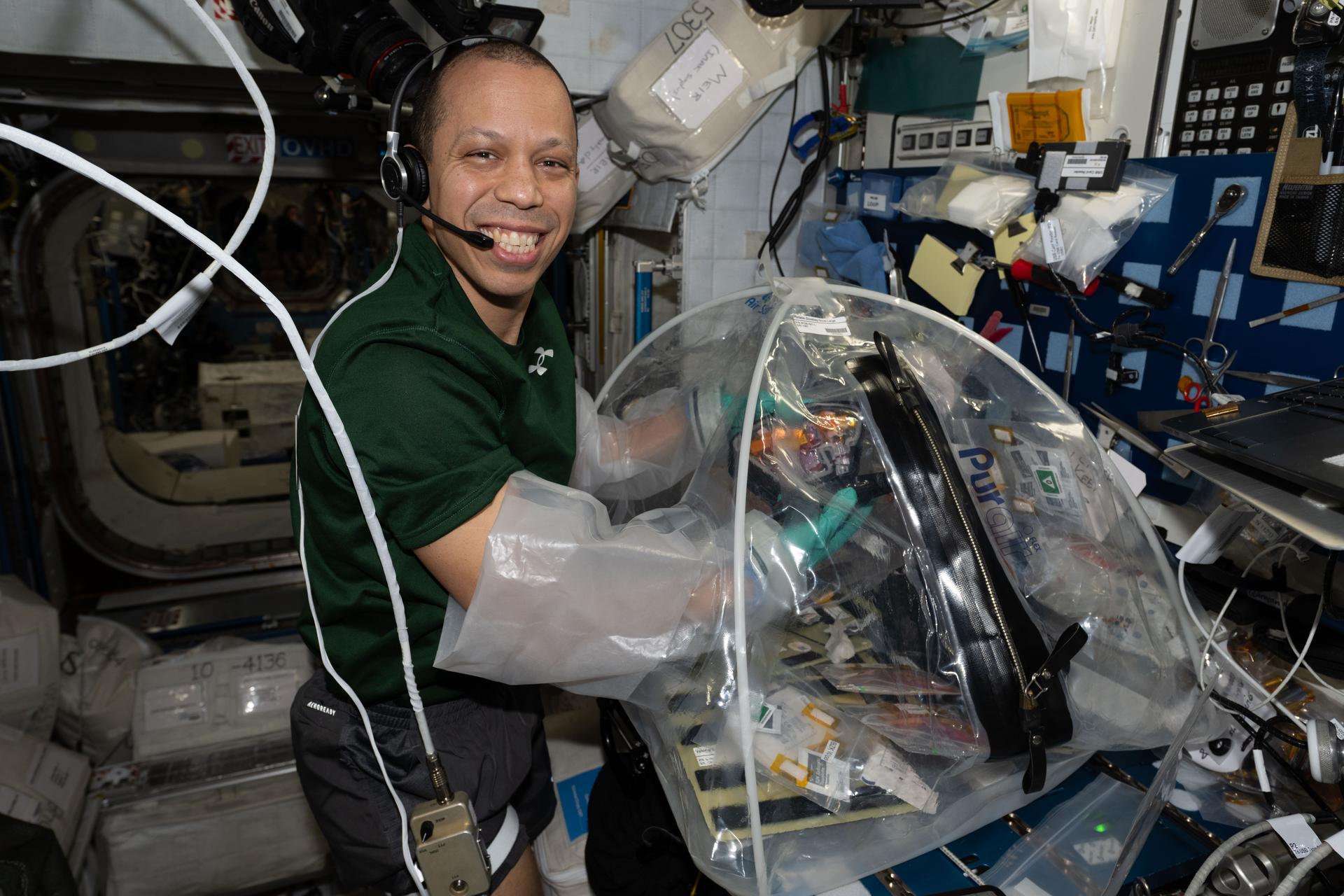 NASA astronaut and Expedition 74 flight engineer Chris Williams configures research hardware inside a portable glovebag for a biotechnology investigation exploring how bacteria affect heart tissue in the microgravity environment. Results from the MVP (Multi-use Variable-g Platform) Cell-09 experiment could lead to advanced methods for preventing or treating heart damage in humans living on and off the Earth.