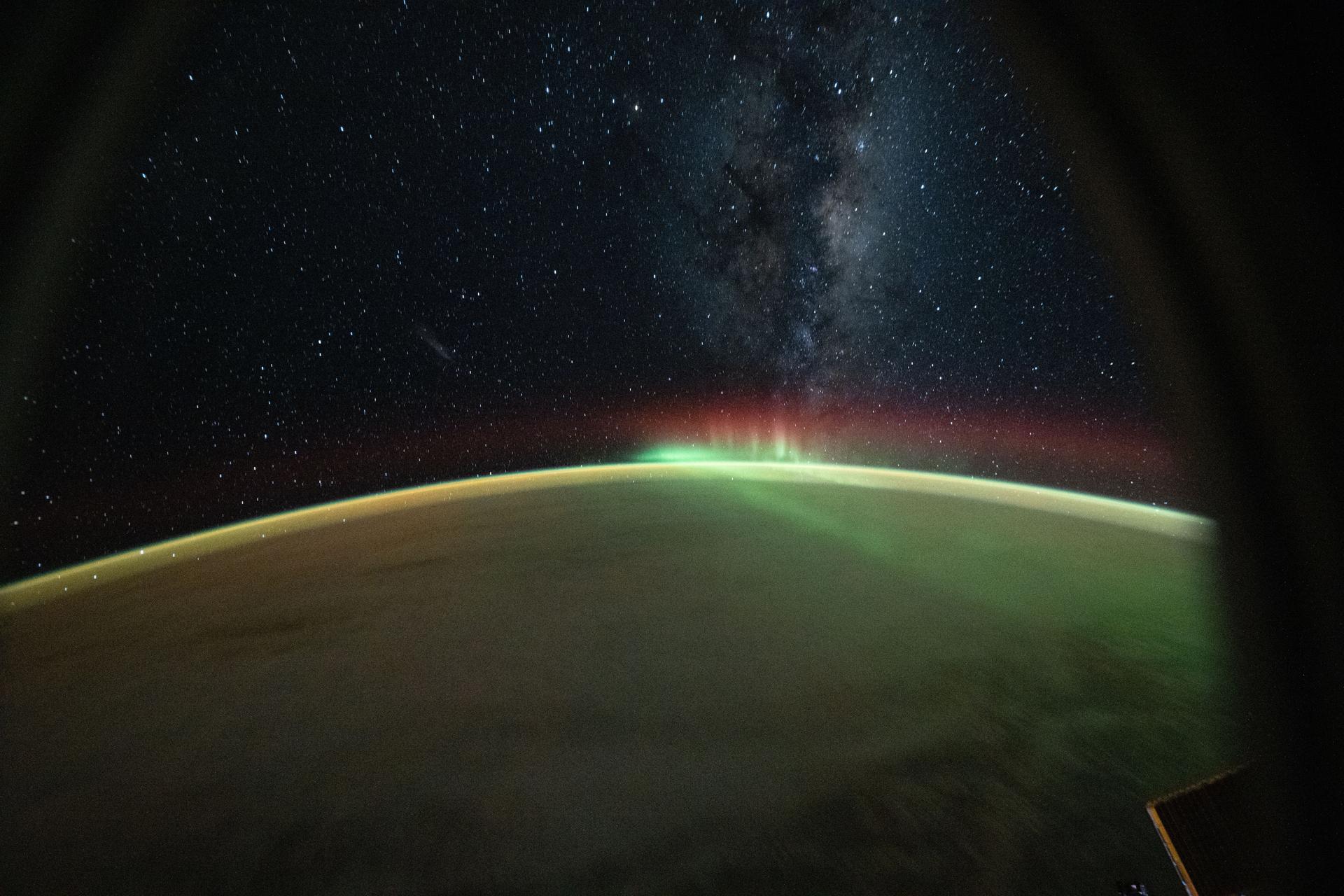 iss074e0491096 (April 17, 2026) --- A wispy aurora australis arcs across the Indian Ocean as the Milky Way protrudes above Earth’s atmosphere in this photograph taken at approximately 8:55 p.m. local time from the International Space Station as it orbited 270 miles above the planet. Credit: NASA/Chris Williams