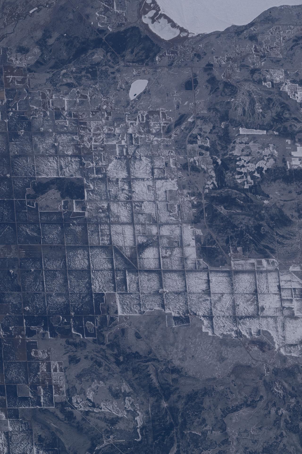 The sub-freezing landscape at the southern tip of Canada’s Lake Winnipeg (top right), where ice fishing is popular, reveals crop fields that will be ready for the seeding of wheat, barley, oats, and canola in late spring and early summer. Cattle and sheep are also raised in the region. The International Space Station was orbiting 267 miles above Ontario when this photograph was taken.