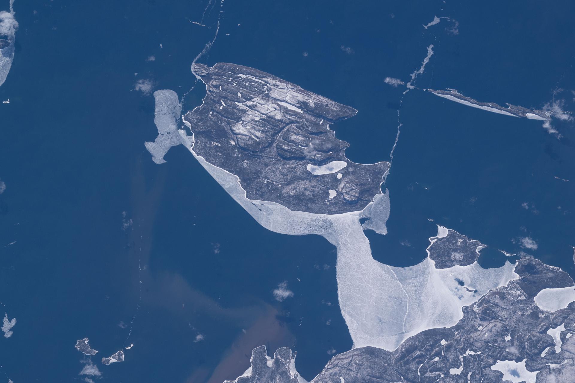 Canada’s uninhabited Pie Island—surrounded by partial ice cover in the northwestern part of Lake Superior just south of Thunder Bay, Ontario—is pictured from the International Space Station as it orbited 267 miles above the great lake.