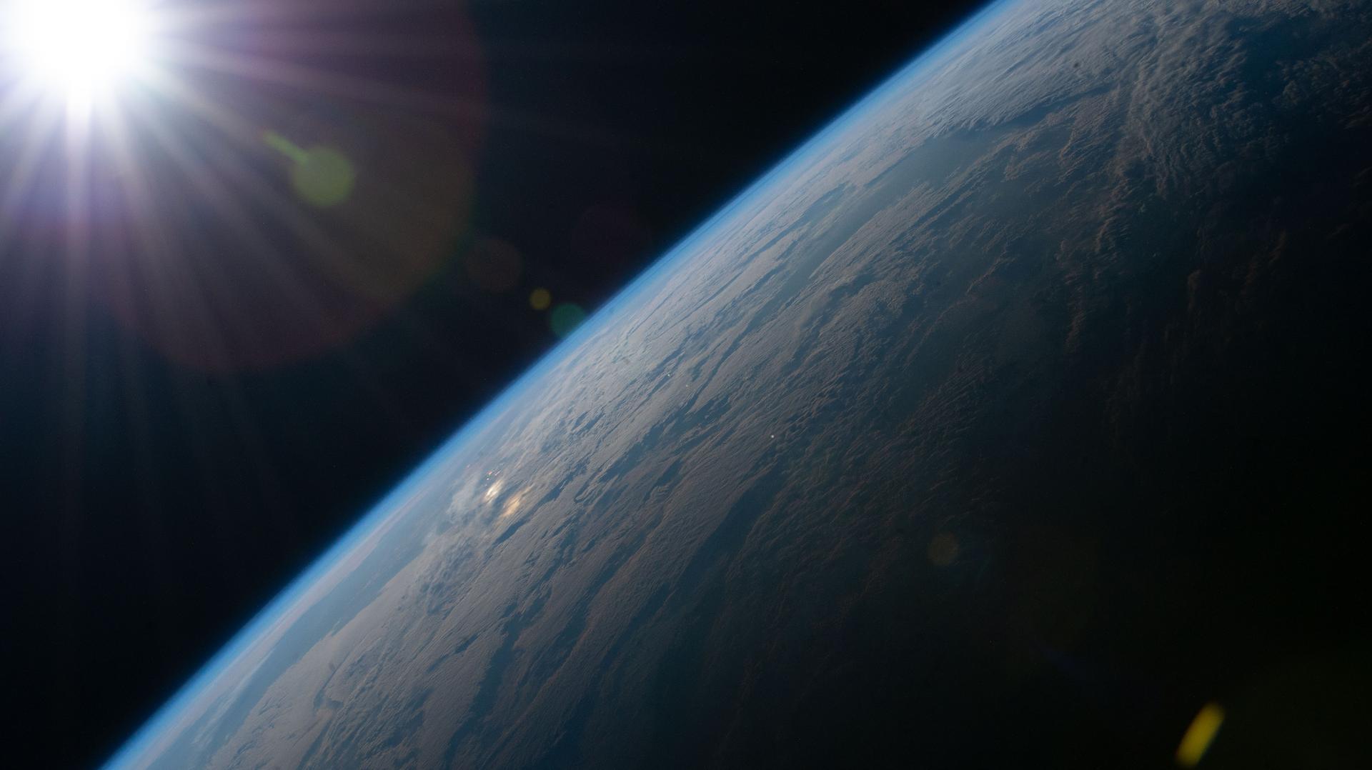 iss074e0494675 (April 21, 2026) --- The Sun begins illuminating Earth’s surface just after an orbital sunrise in this photograph taken at approximately 6:17 a.m. local time from the International Space Station as it orbited 264 miles above southern France. Credit: NASA