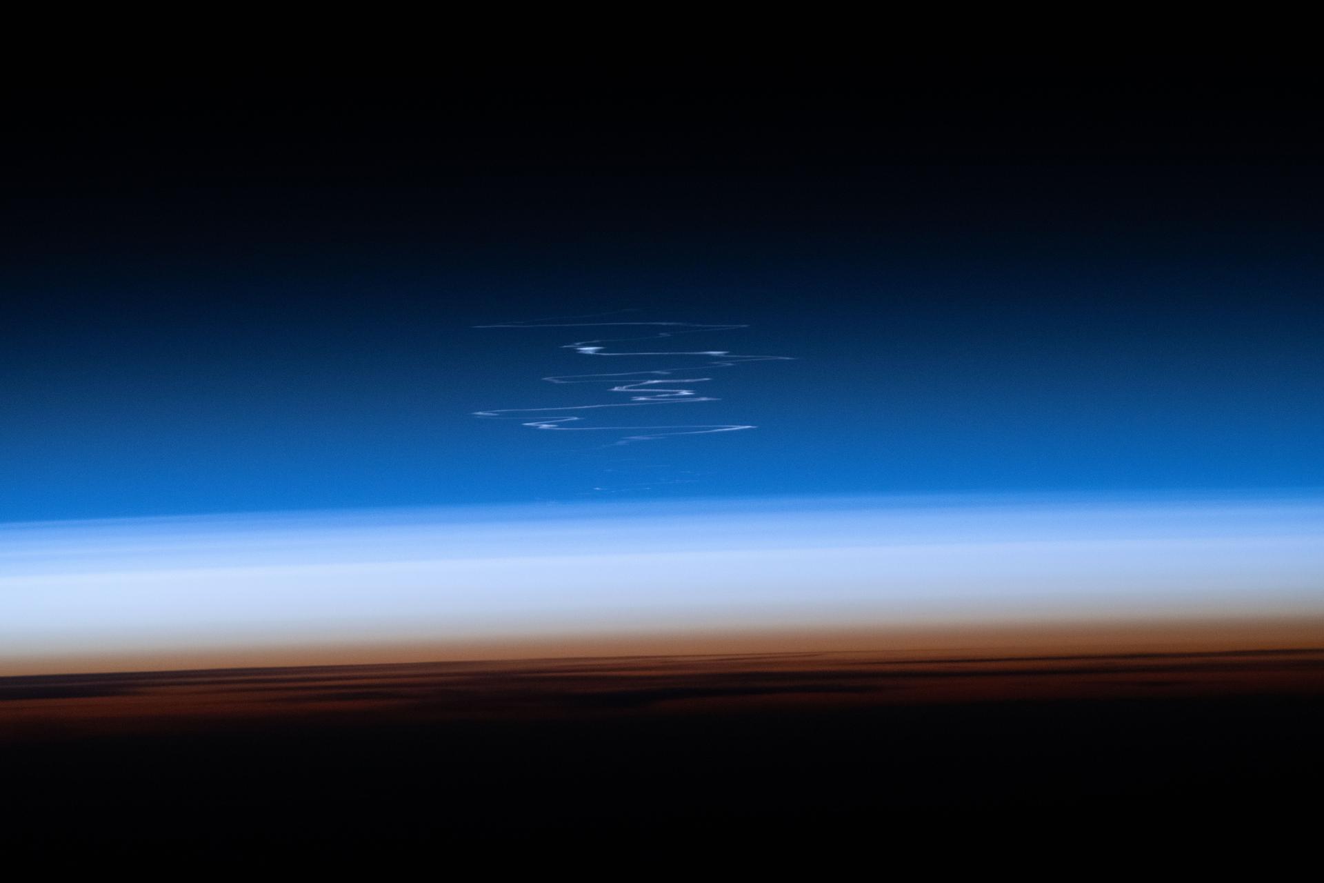 The launch plume from a Progress 95 cargo spacecraft after its liftoff and ascent from the Baikonur Cosmodrome in Kazakhstan is pictured dispersing in the atmosphere from the International Space Station as it orbited 263 miles above the western Asian nation.