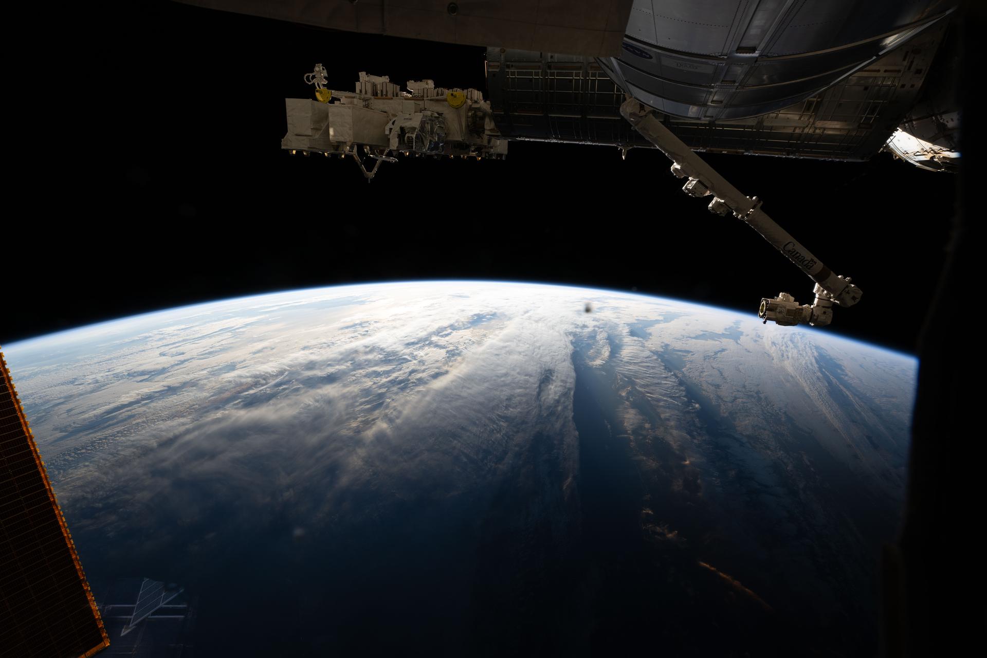The International Space Station orbits above a cloudy Atlantic Ocean