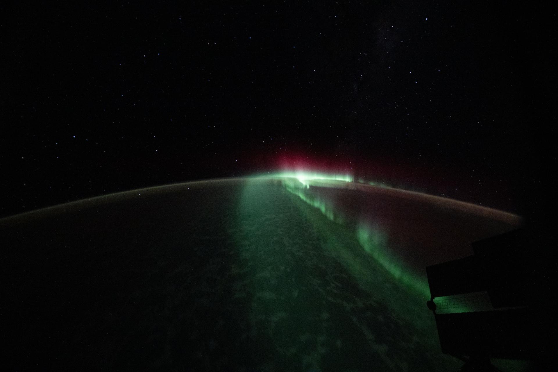 The aurora australis streams serenely above the Indian Ocean southwest of Perth, Australia, in this photograph taken at approximately 10:20 p.m. local time from the International Space Station as it orbited 268 miles above the Earth.