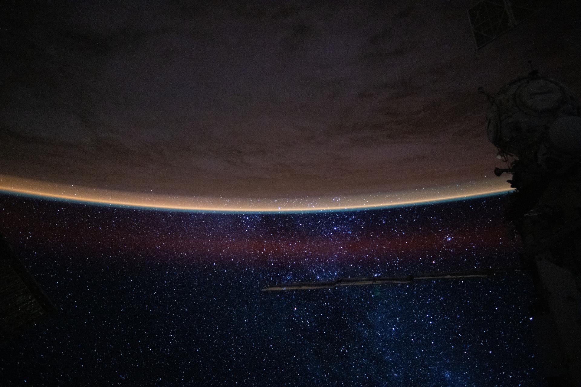 This serene view from the International Space Station captures a bright orange airglow outlining Earth’s horizon beneath the starry expanse of the night sky. The orbital outpost was soaring 259 miles above Colombia at approximately 2:09 a.m. local time when this photograph was taken.
