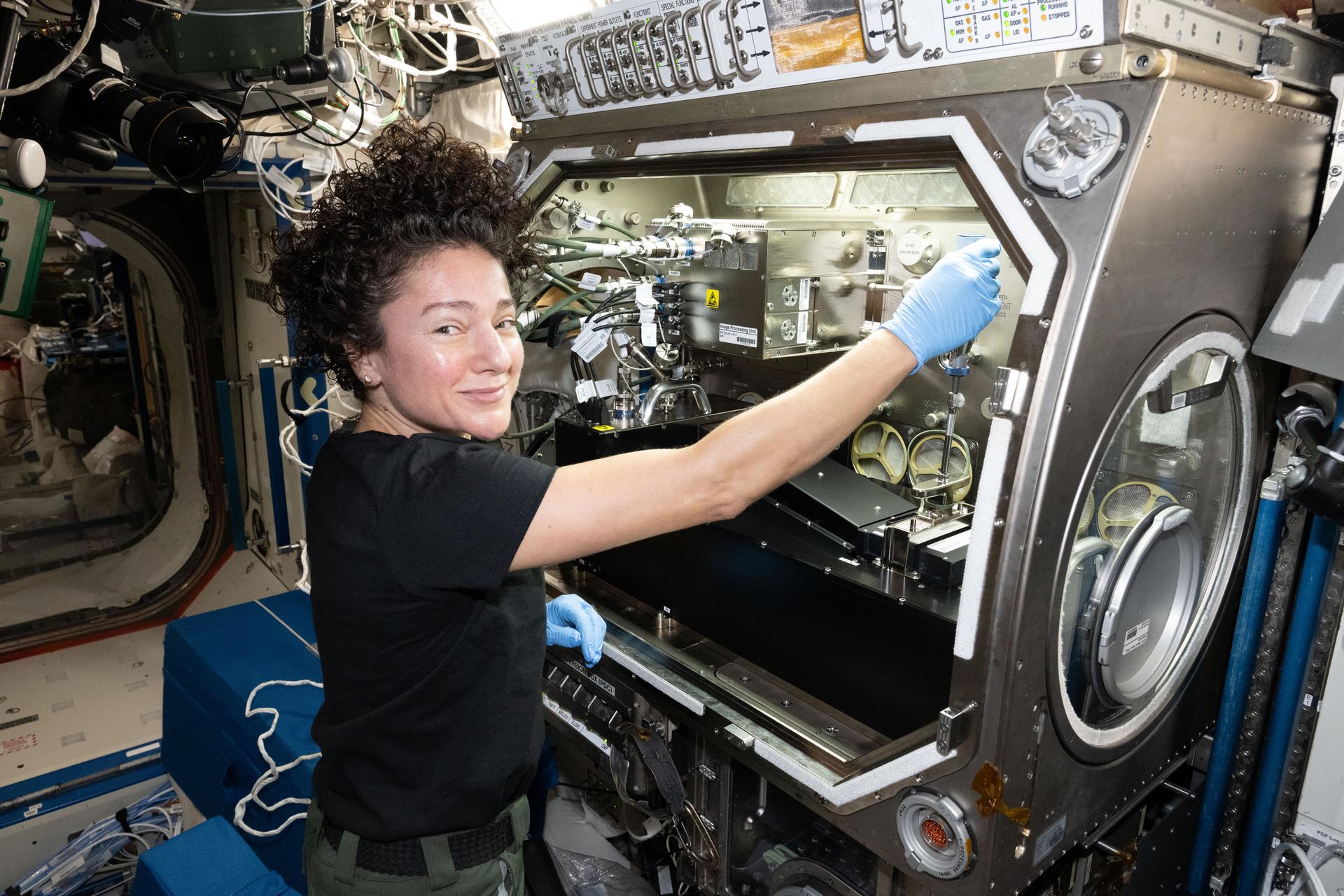 NASA astronaut and Expedition 74 flight engineer Jessica Meir configures research gear inside the Destiny laboratory module's Microgravity Science Glovebox aboard the International Space Station. Meir was exploring how weightlessness affects tiny particles floating in a gelatin-like substance, known as a colloidal solid. Results may lead to advanced manufacturing techniques leading to new medicines, better food textures, and improved personal care products on Earth and in space.