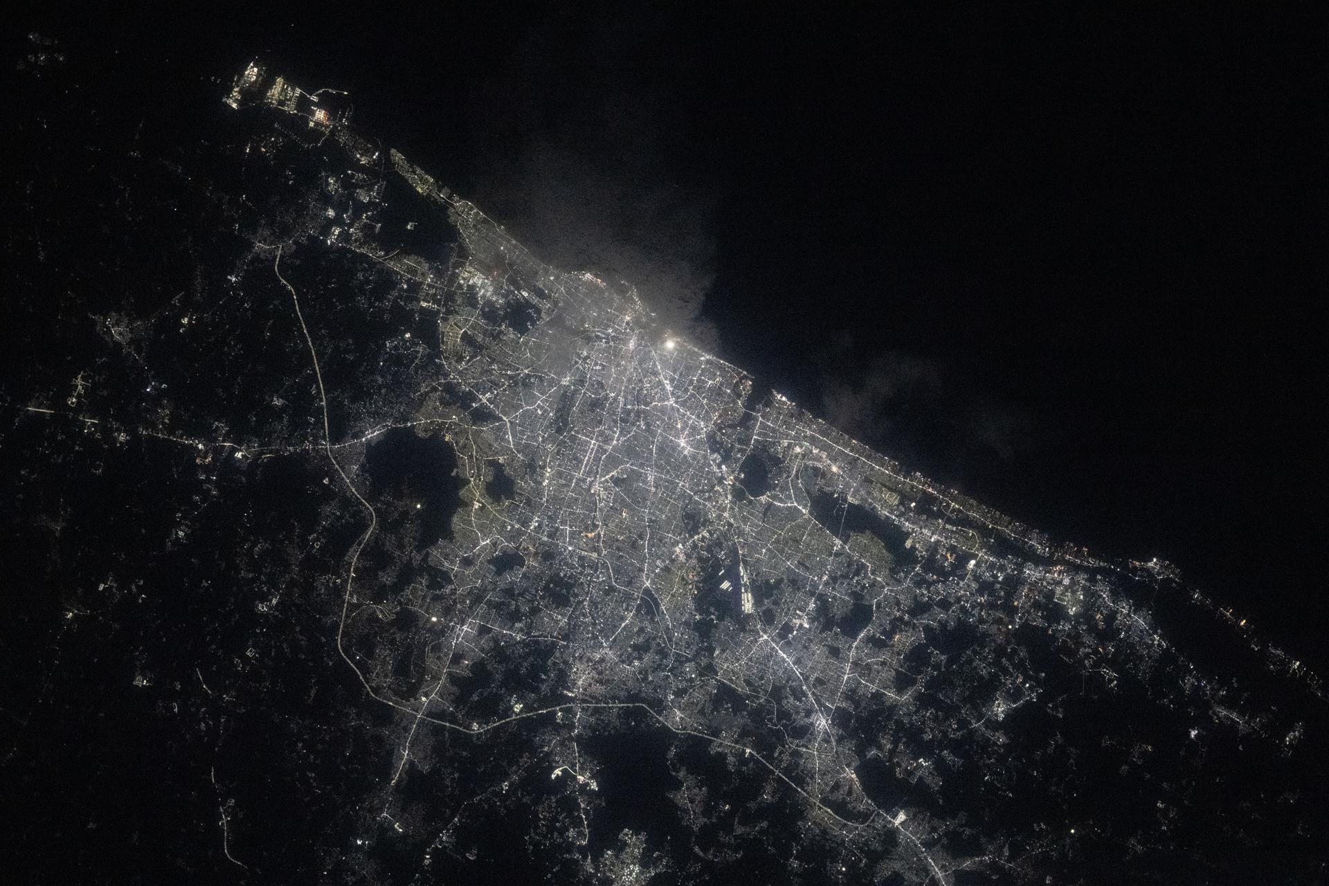 Chennai, on India's southern coast along the Bay of Bengal and with a metropolitan population of about 8.7 million, shines with white LED streetlights in this photograph taken at approximately 9:13 p.m. local time from the International Space Station.