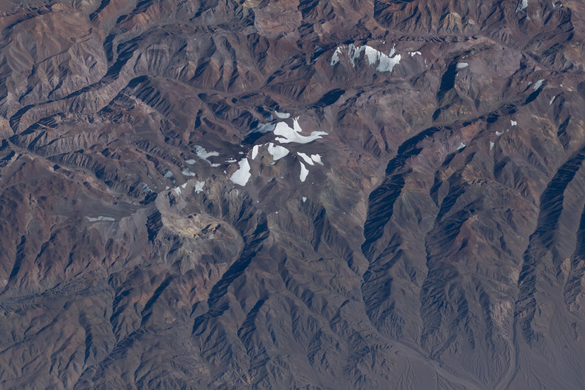 Argentina’s snow‑capped Cerro de la Majadita in the Andes Mountains rises to an elevation of about 20,600 feet above sea level. The International Space Station was orbiting 269 miles above the South American nation when this photograph was taken.
