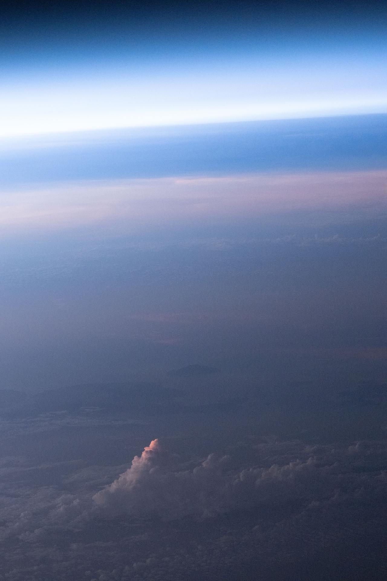 An orbital sunset softens Earth’s atmosphere and cloud tops with light pink and blue hues in this photograph from the International Space Station as it orbited 262 miles above Western Australia’s Indian Ocean coast.