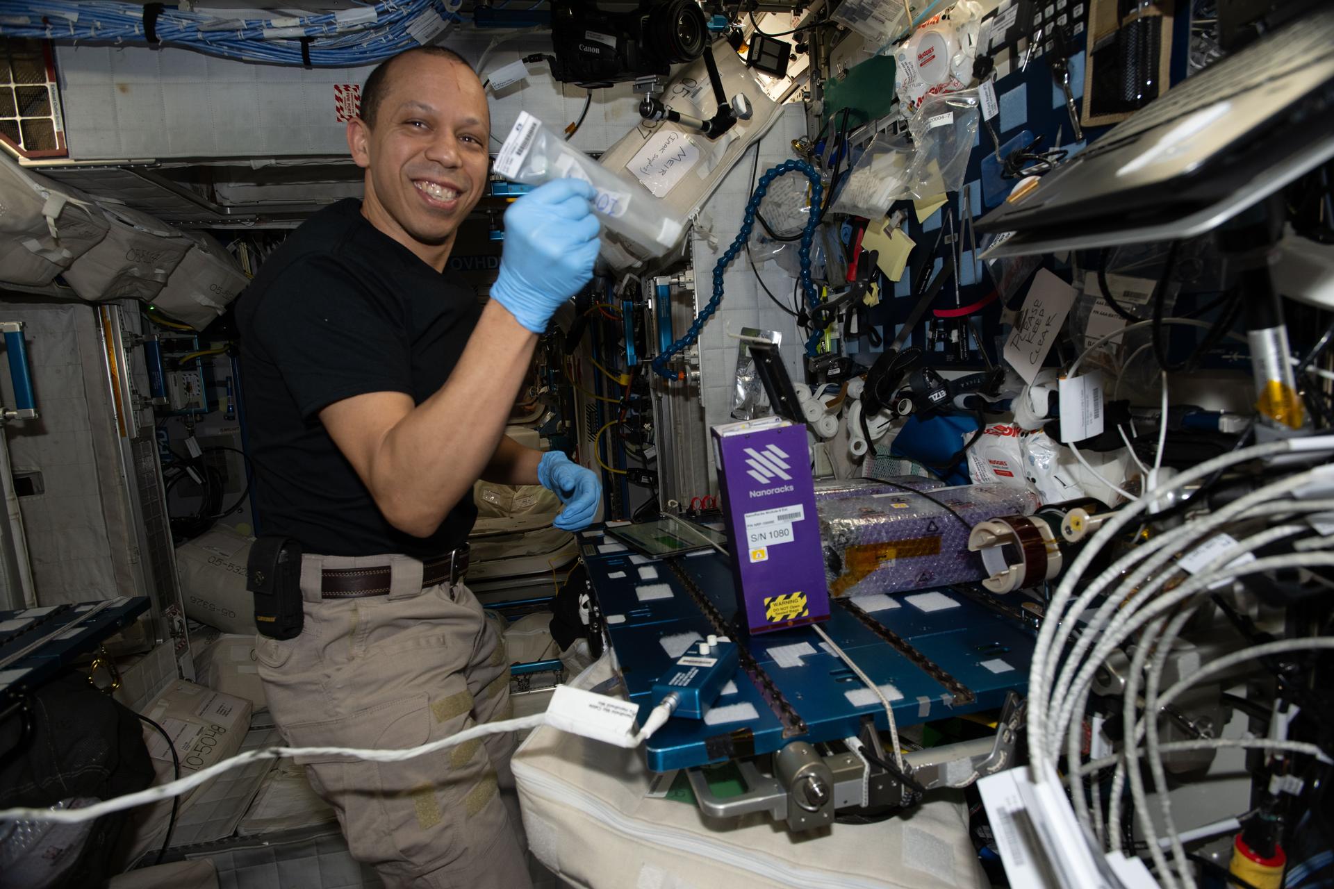 NASA astronaut and Expedition 74 flight engineer Chris Williams activates sample‑containing tubes for a variety of student‑designed experiments using NanoRacks research hardware. The tubes were filled with biological and material samples to help expand knowledge of space phenomena and inspire junior high and high school students to consider scientific, technical, and engineering careers.