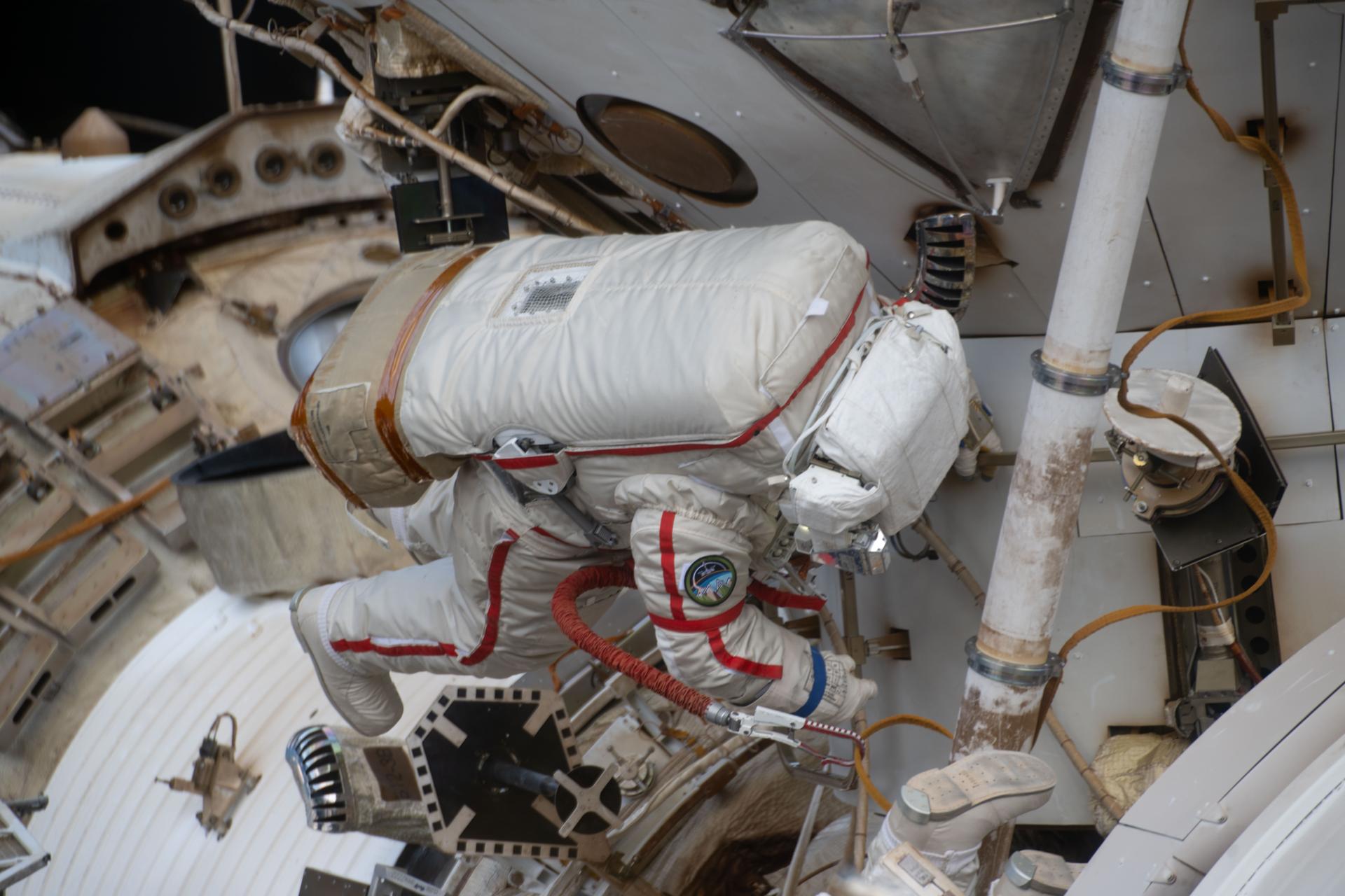 Roscosmos cosmonaut and Expedition 74 commander Sergey Kud-Sverchkov works outside the International Space Station in his Orlan spacesuit with red stripes. During the six-hour and five-minute spacewalk, Kud‑Sverchkov, along with Roscosmos cosmonaut Sergei Mikaev (out of frame), installed a solar radiation experiment and removed physics and microbiology research hardware from the orbital outpost.