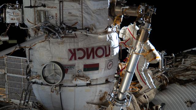 Cosmonaut Sergey Kud-Sverchkov works outside the International Space Station in his Orlan spacesuit with red stripes