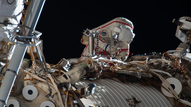 Cosmonaut Sergey Kud-Sverchkov works outside the International Space Station in his Orlan spacesuit with red stripes
