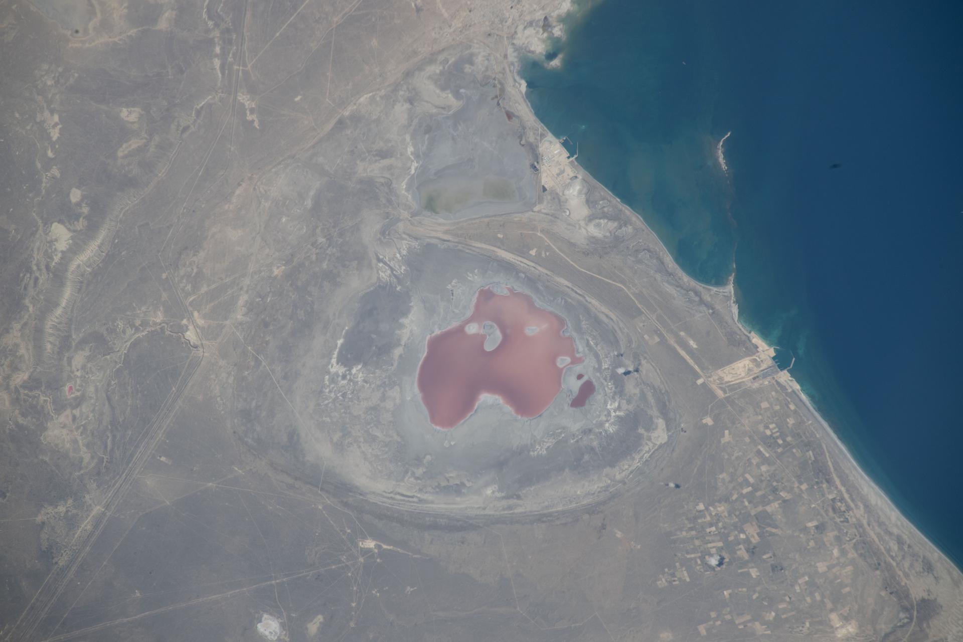 Kazakhstan’s Munaily District, near the Caspian Sea shoreline, is a sparsely populated region with exposed flats and a rapid decline in water level due to evaporation and reduced input from the Volga River. Ports along the Caspian shoreline support the petroleum, chemical, and agriculture industries. The International Space Station was orbiting 263 miles above eastern Kazakhstan at the time of this photograph.
