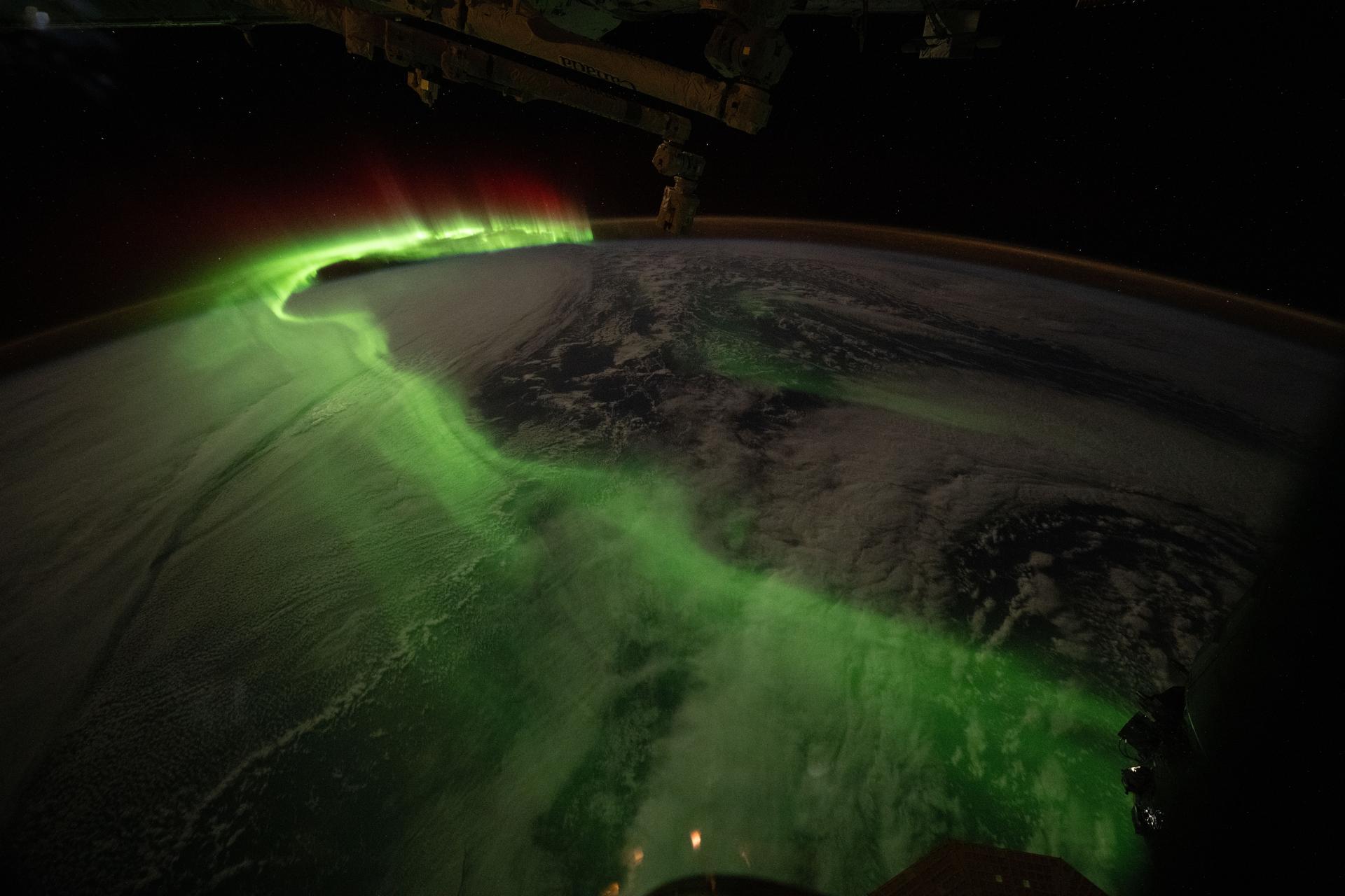 The aurora australis arcs over Earth during an active solar event in this photograph taken at approximately 11:32 p.m. local time from the International Space Station as it orbited 271 miles above the Indian Ocean southwest of Perth, Australia.