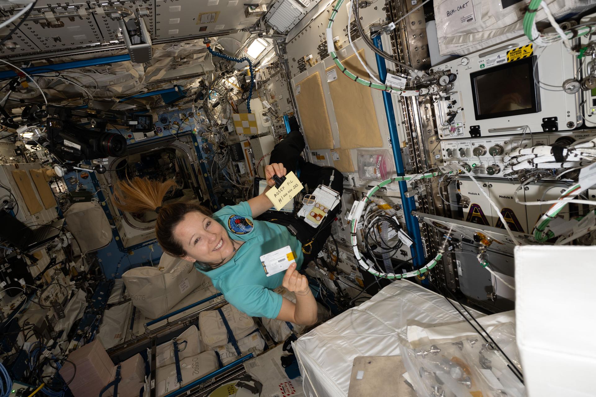 ESA (European Space Agency) astronaut and Expedition 74 flight engineer Sophie Adenot swaps hard drives inside the Advanced Space Experiment Processor-4, a research device that supports the processing of scientific samples, increasing the International Space Station's capacity for microgravity research.