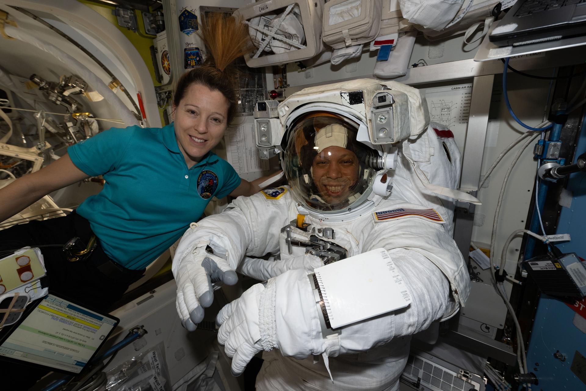 Flight engineer Sophie Adenot of ESA (European Space Agency) assists flight engineer Chris Williams of NASA as he tries on his spacesuit, testing its comfort and mobility as well as its communications and life support systems inside the International Space Station’s Quest airlock. Williams was preparing for a spacewalk to replace a malfunctioning wrist joint on the Canadarm2 robotic arm, planned for June 30, 2026.