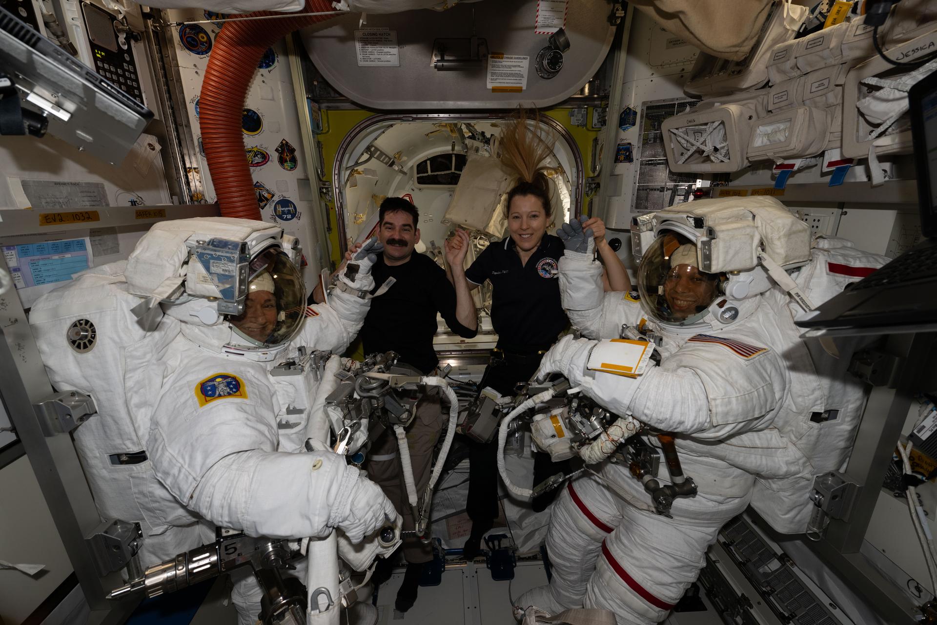 At center, Expedition 74 flight engineers Jack Hathaway of NASA and Sophie Adenot of ESA (European Space Agency) pose for a portrait with NASA flight engineers Jessica Meir (far left) and Chris Williams (far right) after assisting the pair into their spacesuits inside the International Space Station’s Quest airlock. Shortly afterward, Meir and Williams exited Quest to begin a seven‑hour‑and‑20‑minute spacewalk to replace a malfunctioning wrist joint on the Canadarm2 robotic arm.
