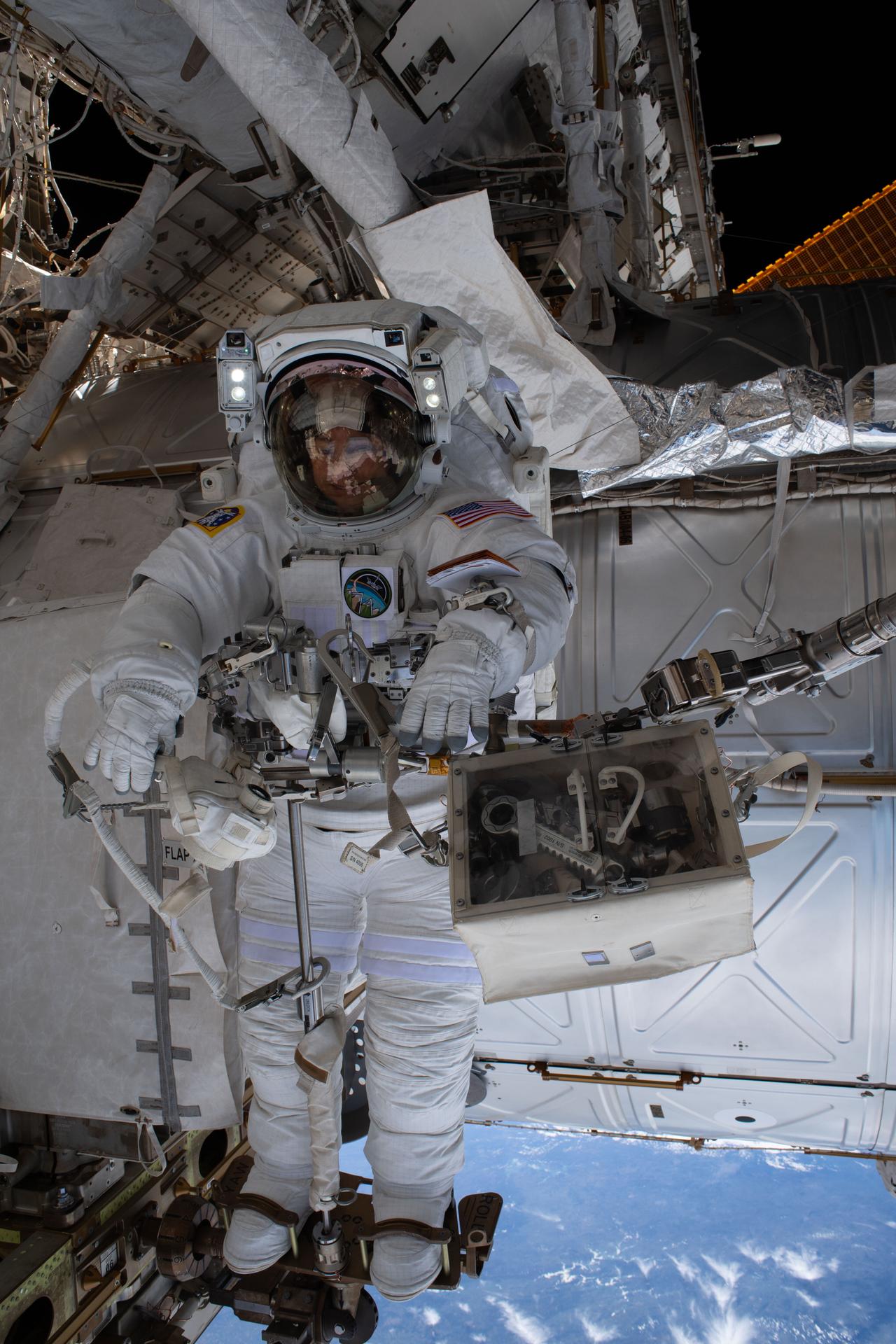 NASA astronaut and Expedition 74 flight engineer Jessica Meir is pictured attached to an articulating portable foot restraint during a seven‑hour‑and‑20‑minute spacewalk to replace a malfunctioning wrist joint on the International Space Station’s Canadarm2 robotic arm.