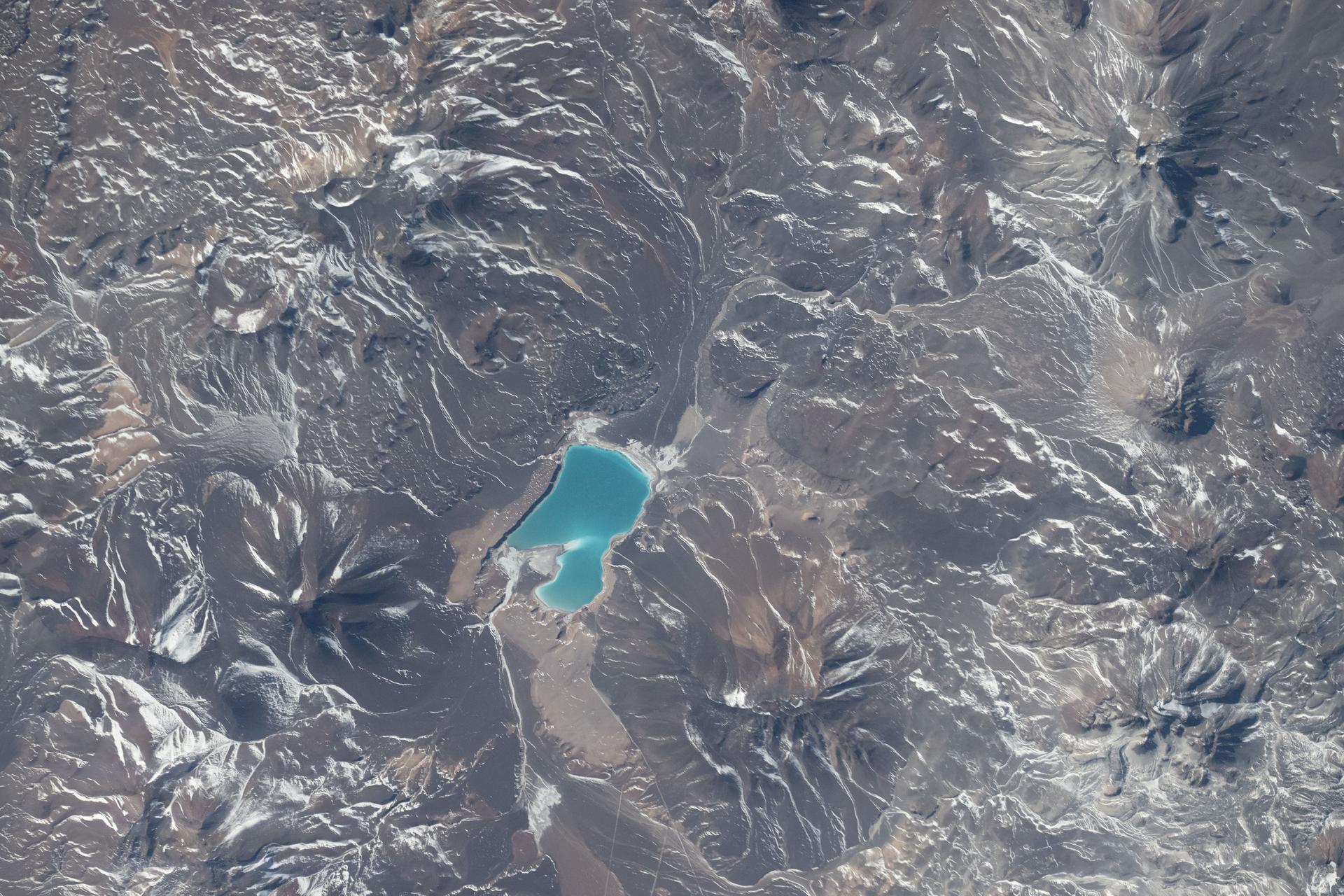 Laguna Verde, a high-altitude salt lake at approximately 14,200 feet (4,328 meters) above sea level, sits in Chile’s northern Atacama Region in the Andes Mountains near the border with Argentina. The International Space Station was orbiting 264 miles above the South American nation at the time this photograph was taken.
