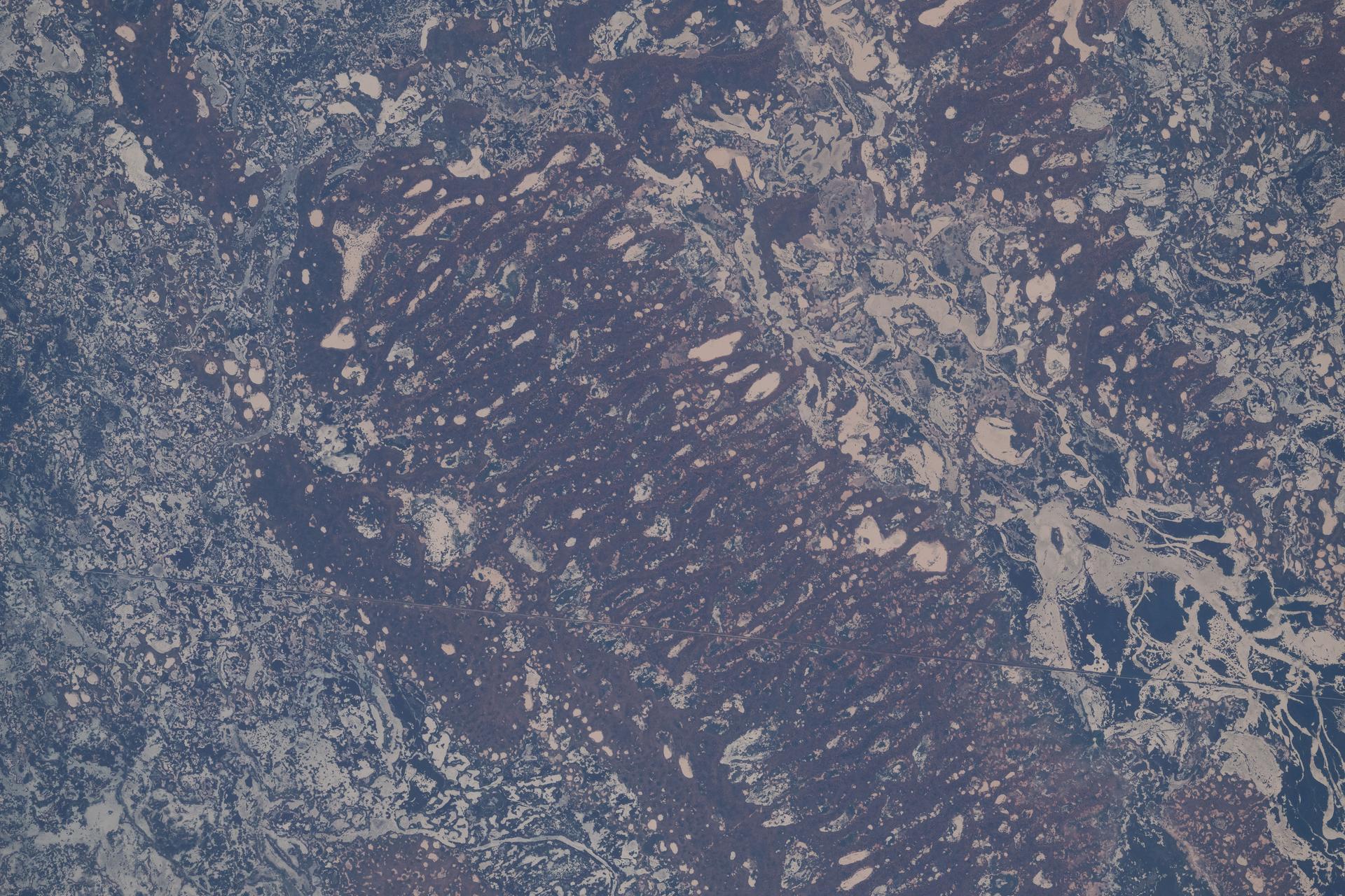 The far west region of New South Wales, Australia, along the Darling River transforms dramatically from semi‑arid plains into a vast inland wetland system during episodic heavy rainfall. The high biodiversity of the region supports woodlands, shrublands, and wildlife including kangaroos, waterbirds, reptiles, and more. The International Space Station was orbiting 265 miles above Earth at the time of this photograph.
