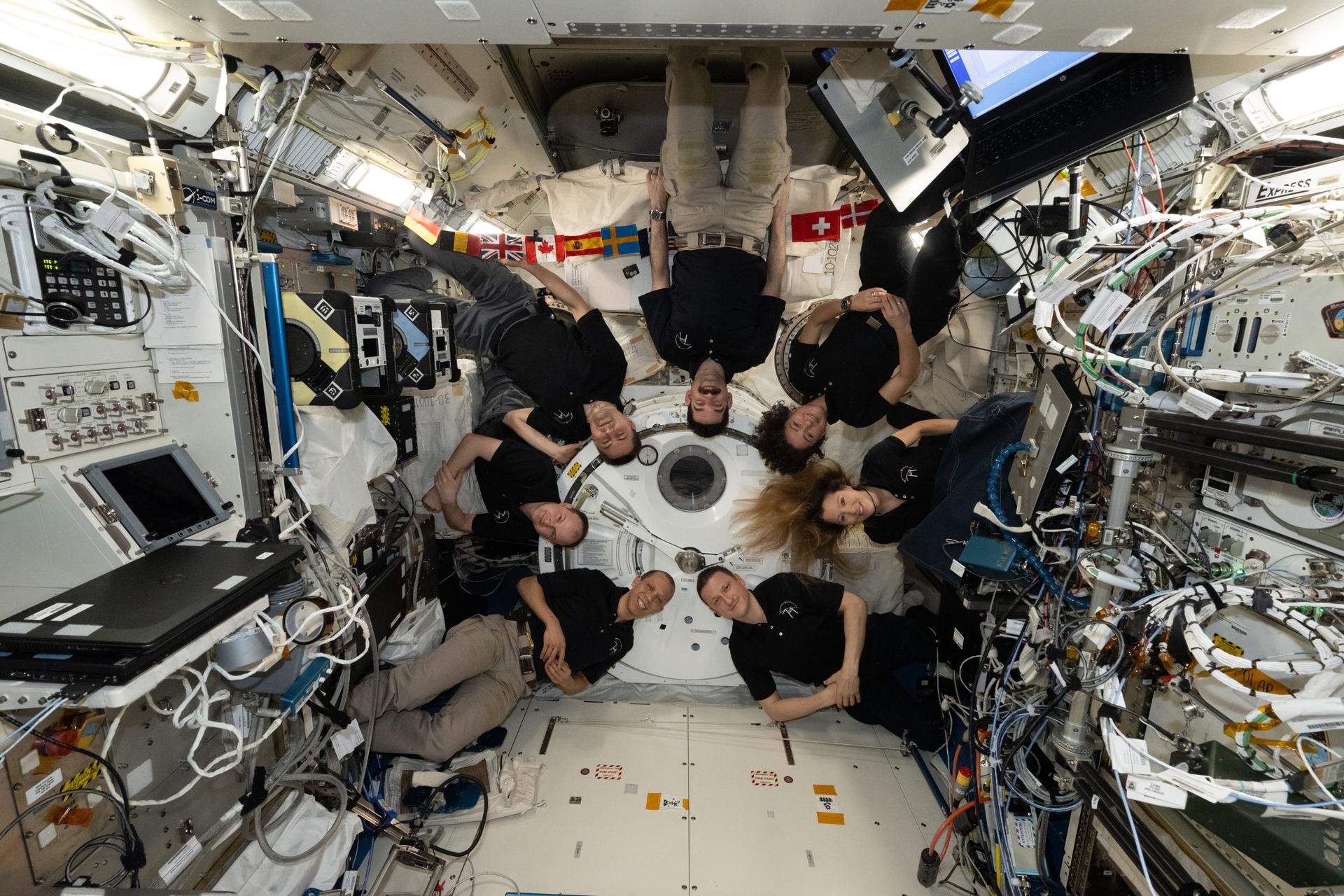 The seven-member Expedition 74 crew poses together for a fun portrait inside the International Space Station's Kibo laboratory module. Clockwise from bottom left, are NASA astronaut Chris Williams, Roscosmos cosmonauts Sergei Mikaev and Andrey Fedyaev, NASA astronauts Jack Hathaway and Jessica Meir, ESA (European Space Agency) astronaut Sophie Adenot, and Roscosmos cosmonaut Sergey Kud-Sverchkov.