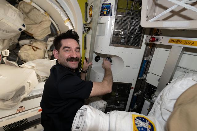 NASA astronaut Jack Hathway signs his autograph inside the International Space Station