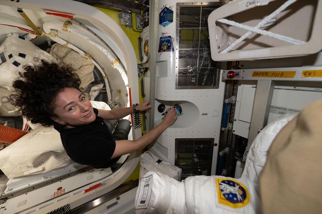 NASA astronaut Jessica Meir signs her autograph inside the International Space Station