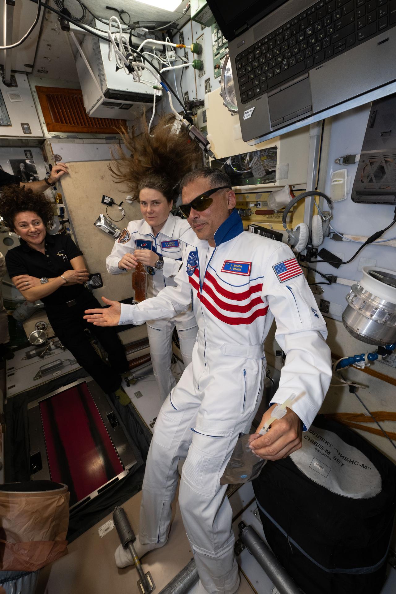 From left, Expedition 74 flight engineer Jessica Meir of NASA smiles after welcoming Roscosmos cosmonaut Anna Kikina and NASA astronaut Anil Menon aboard the International Space Station following their docking to the Prichal module inside the Soyuz MS-29 spacecraft with Roscosmos cosmonaut Pyotr Dubrov (out of frame).