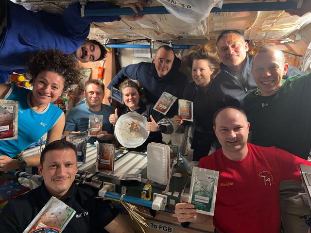 All ten International Space Station crew members gather inside the Unity module for a portrait during dinnertime