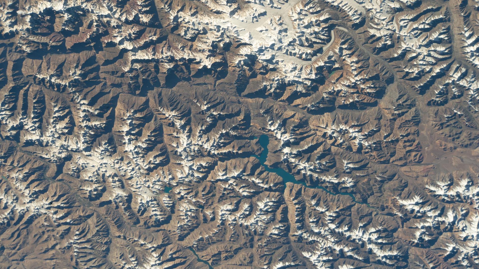 Sarez Lake, a large alpine lake created by a catastrophic earthquake in the early 20th century, lies within Tajik National Park located in Tajikistan's Pamir Mountains. The International Space Station was orbiting 264 miles above Central Asia at the time of this photograph.