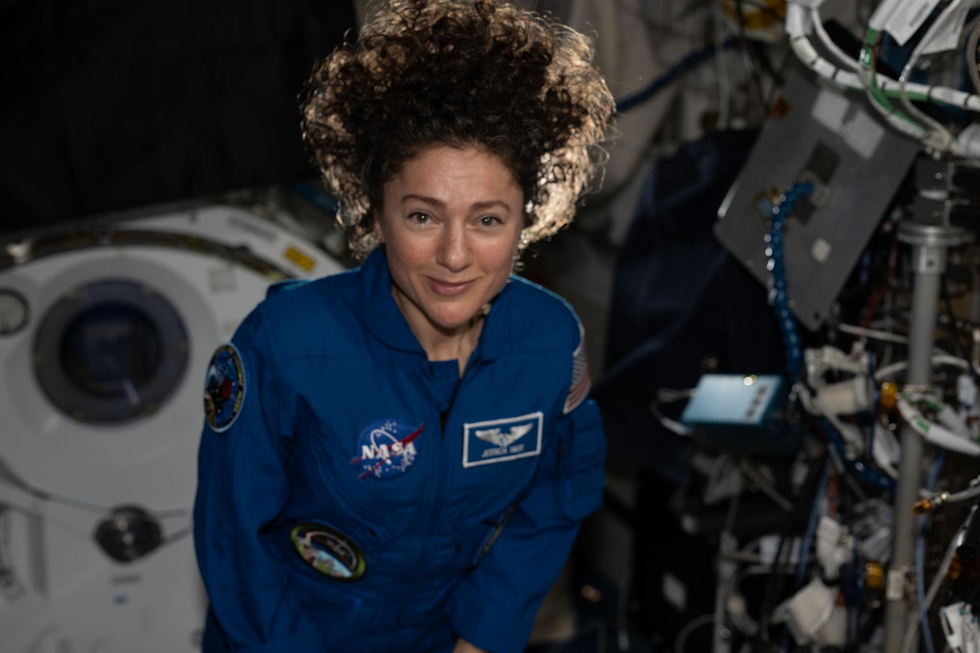 NASA astronaut Jessica Meir poses for a portrait inside the Kibo laboratory module after acccepting command of the International Space Station from Roscosmos cosmonaut Sergey Kud-Sverchkov (out of frame). Meir will lead the Expedition 75 crew until the end of summer.