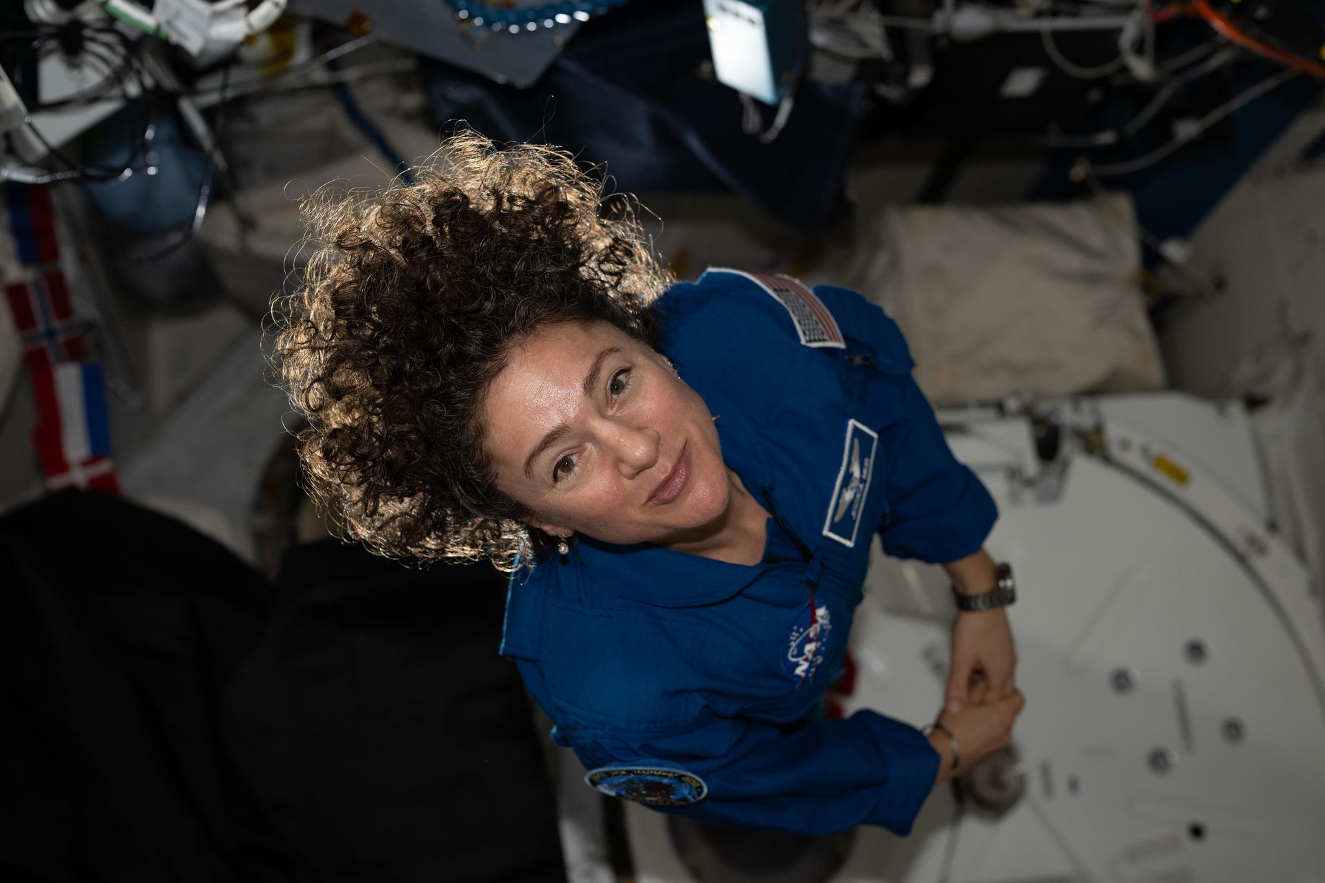 iss074e0835232 (July 25, 2026) --- NASA astronaut Jessica Meir poses for a portrait inside the Kibo laboratory module after acccepting command of the International Space Station from Roscosmos cosmonaut Sergey Kud-Sverchkov (out of frame). Meir will lead the Expedition 75 crew until the end of summer. Credit: NASA/Anil menon