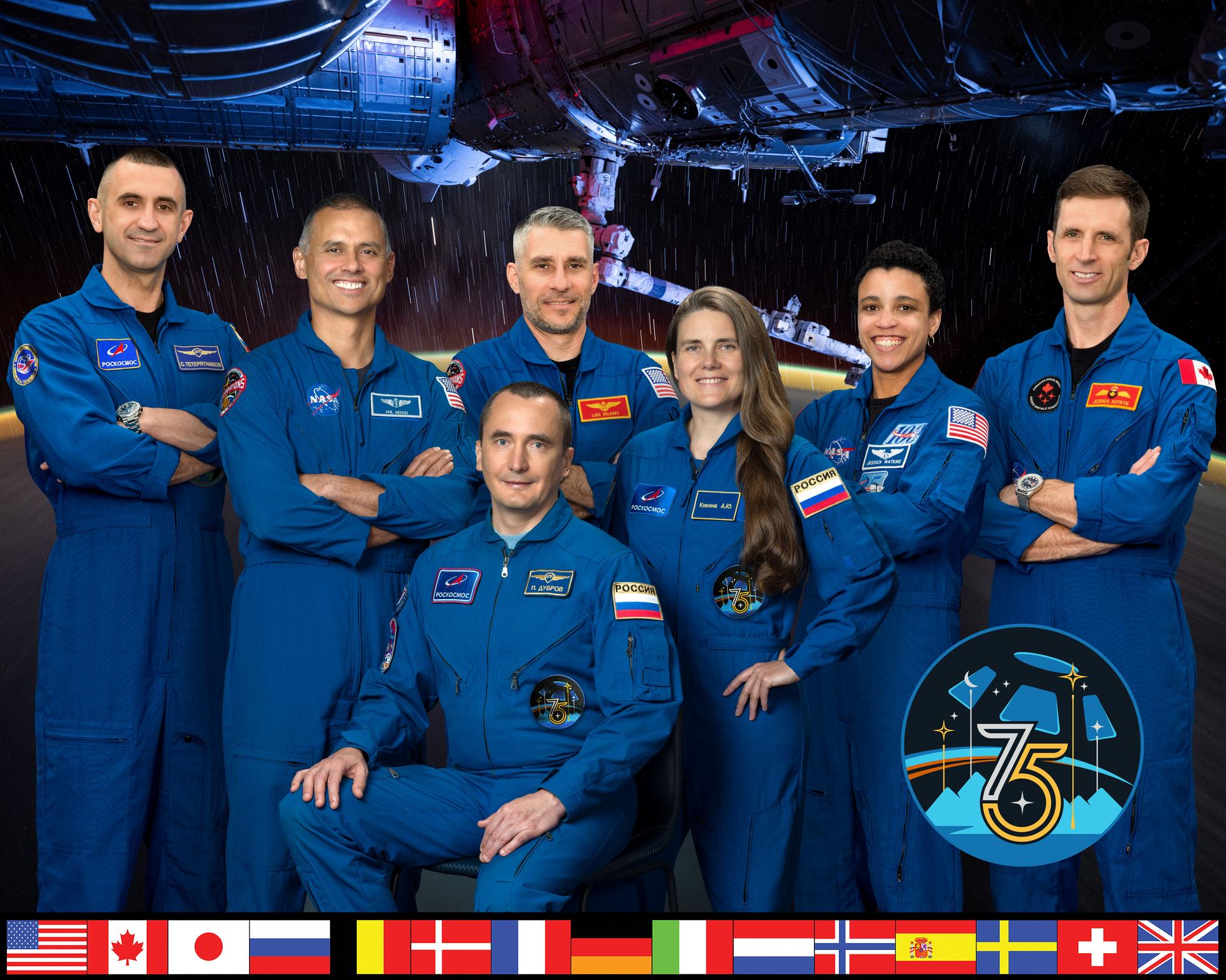 iss075-s-002a (Oct. 16, 2024) --- The official portrait of the seven‑member Expedition 75 crew that will live and work aboard the International Space Station. From left, are Roscosmos cosmonaut Sergey Teteryatnikov; NASA astronaut Anil Menon; Roscosmos cosmonaut Pyotr Dubrov; NASA astronaut Luke Delaney; Roscosmos cosmonaut Anna Kikina; NASA astronaut Jessica Watkins; and CSA (Canadian Space Agency) astronaut Joshua Kutryk. Credit: NASA