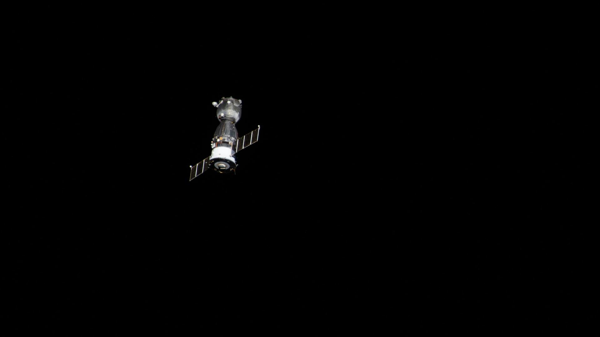 iss075e0000010 (July 26, 2026) --- The Soyuz MS-28 spacecraft departs the vicinity of the International Space Station after undocking from the Rassvet module. NASA astronaut Chris Williams and Roscosmos cosmonauts Sergey Kud-Sverchkov and Sergei Mikaev rode the Soyuz back to Earth and parachuted to a landing in Kazakhstan just over three hours later. Credit: NASA