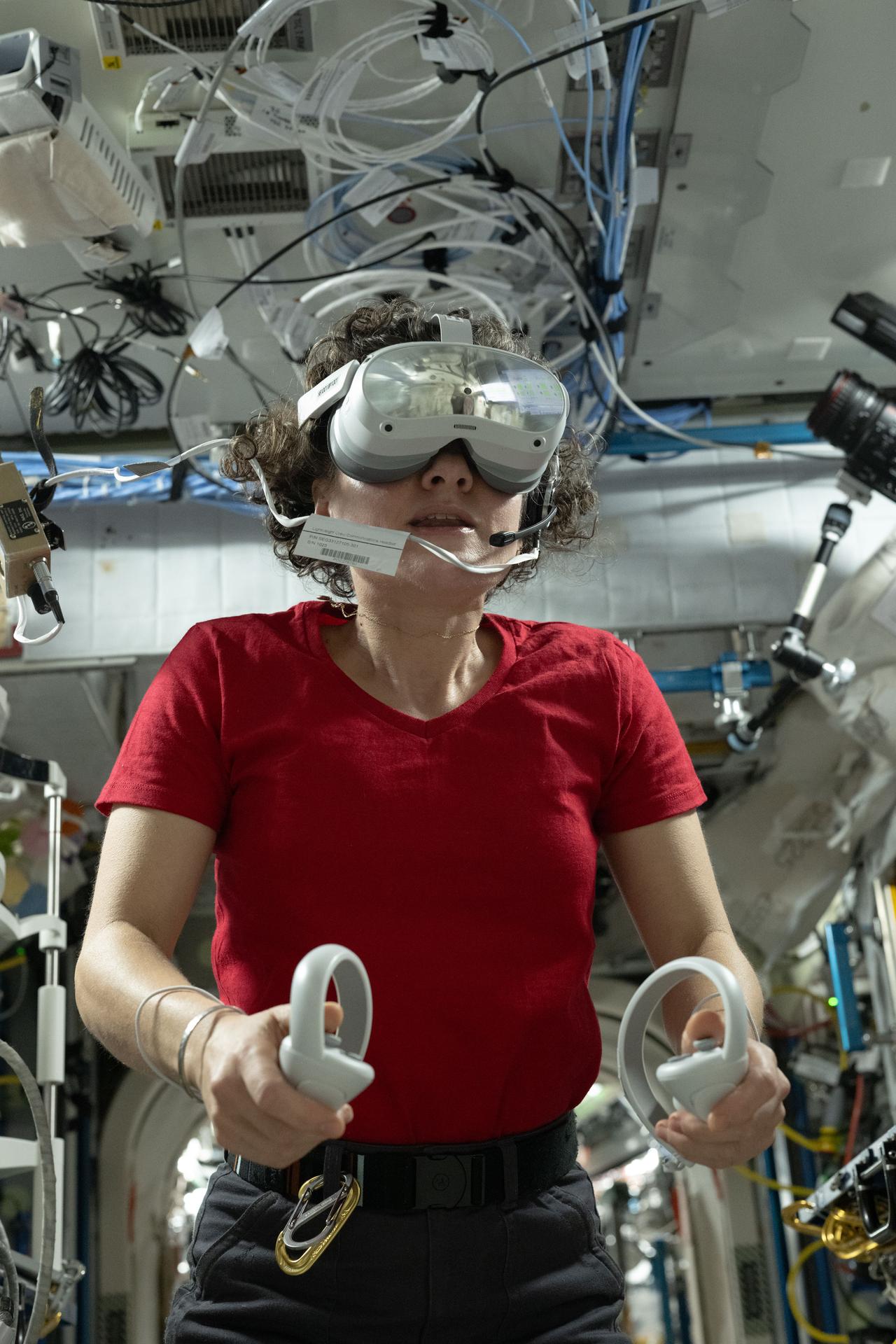 iss075e0000191 (July 29, 2026) --- NASA astronaut and Expedition 75 commander Jessica Meir wears a set of virtual reality goggles, also called the Nevada Screening Vision System, for a test that measures visual function using a series of vision screening apps testing visual acuity, contrast sensitivity, and more. Credit: NASA/Anil Menon
