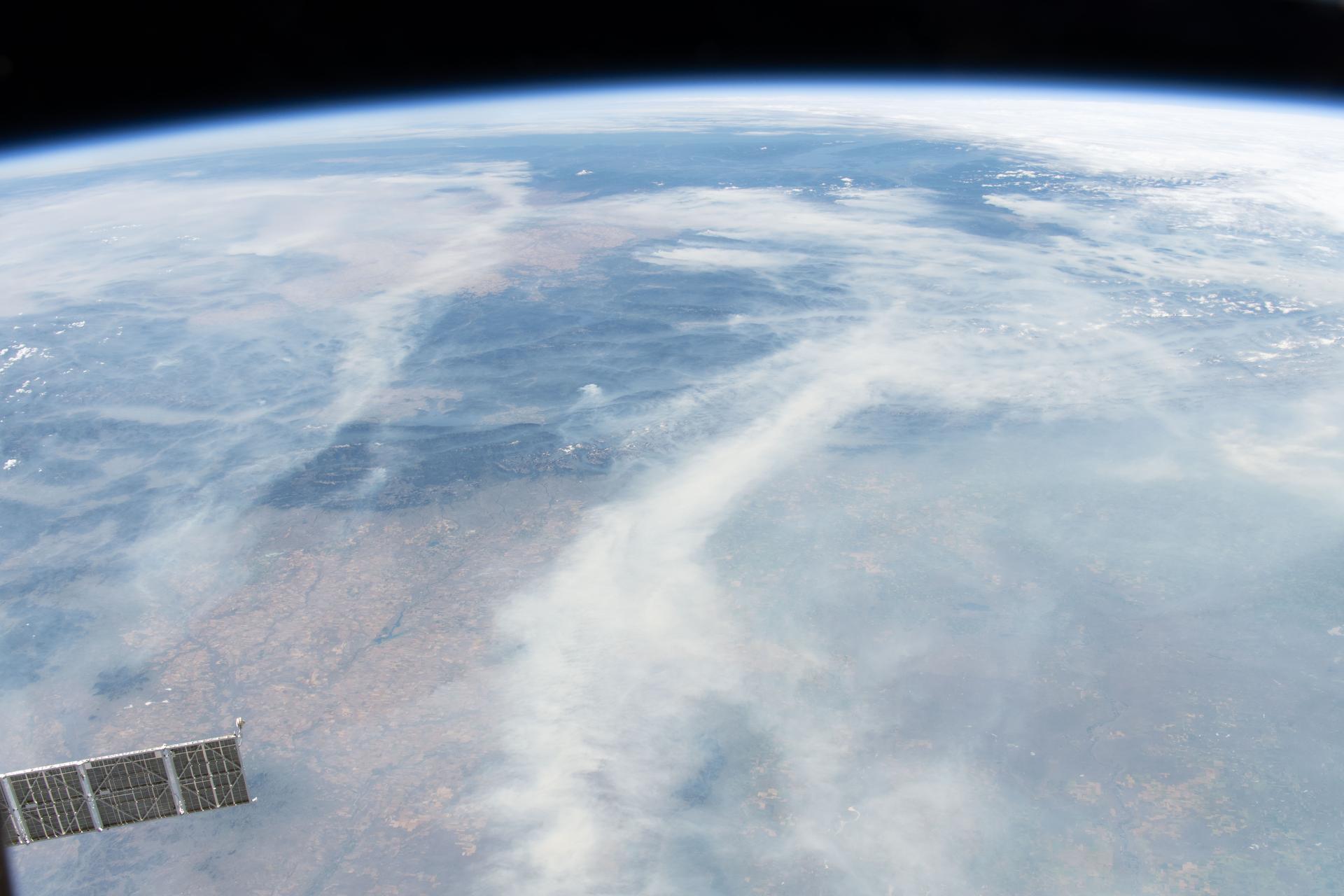 iss075e0001813 (July 31, 2026) --- Smoke from wildfires burning across North America’s Pacific Northwest region blankets the atmosphere, creating hazy conditions. The International Space Station was orbiting 263 miles above Canada at the time of this photograph. Credit: NASA/Jack Hathaway