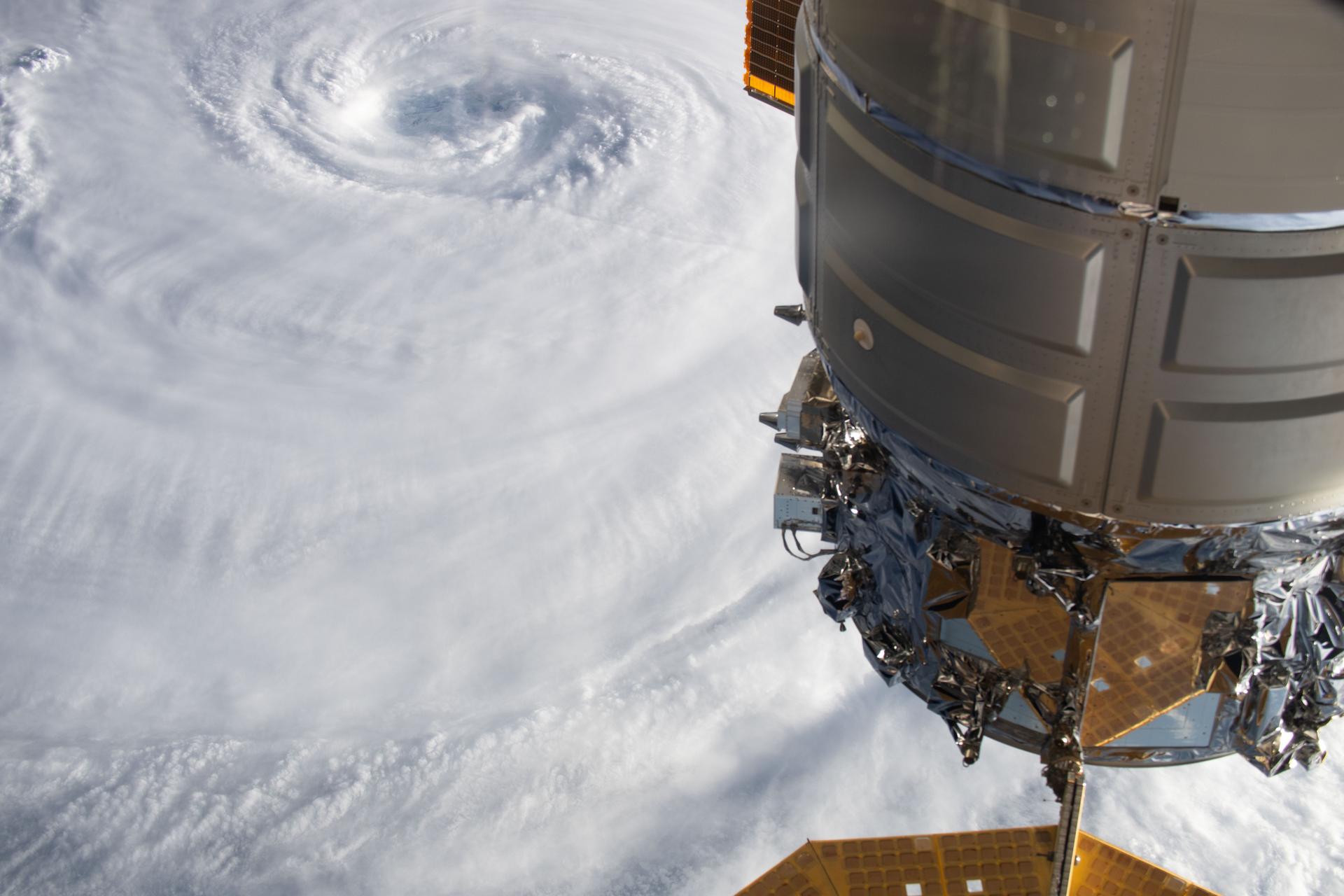 Typhoon Dolphin, with its well-defined eye, is pictured as a Category 4 storm in the Pacific Ocean from the International Space Station as it orbited 264 miles above Earth. In the foreground, is Northrop Grumman's Cygnus XL cargo spacecraft.
