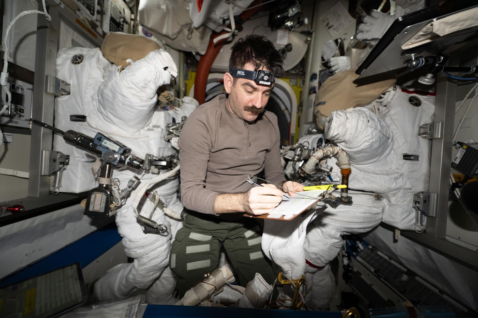 iss075e0002773 (Aug. 5, 2026) --- NASA astronaut and Expedition 75 flight engineer Jack Hathaway works inside the International Space Station's Quest airlock, checking tools and spacesuits the day before NASA astronauts Jessica Meir and Anil Menon (both out of frame) conducted a spacewalk. During the spacewalk, they installed hardware on the orbital outpost's Starboard 6 truss segment to prepare it for future power system upgrades. Credit: NASA/Anil Menon