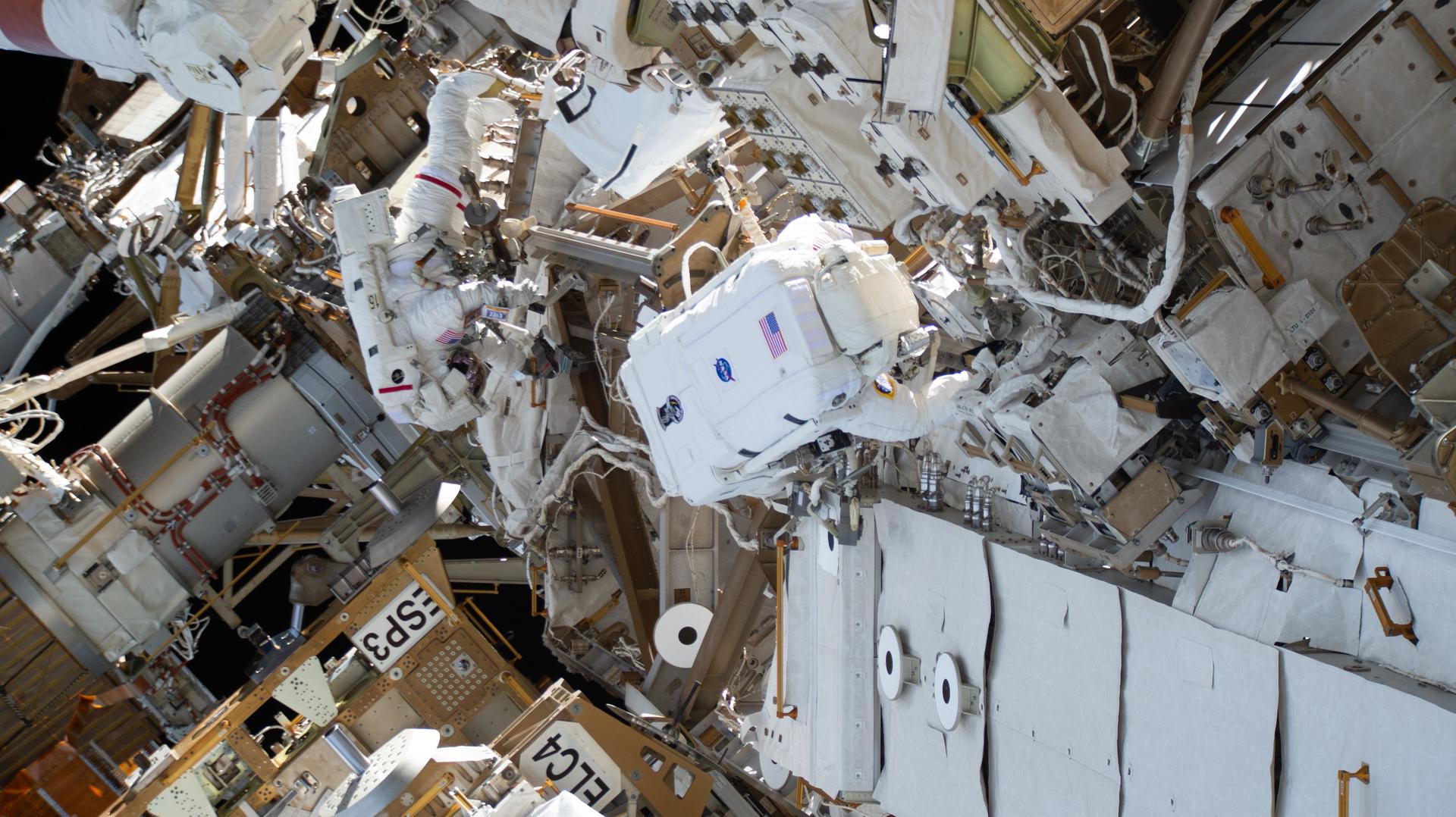 From left, astronauts Anil Menon of NASA and Sophie Adenot of ESA (European Space Agency) conduct a spacewalk to disconnect a failed space-to-ground antenna outside the International Space Station on the Z1 truss segment above the Unity module.