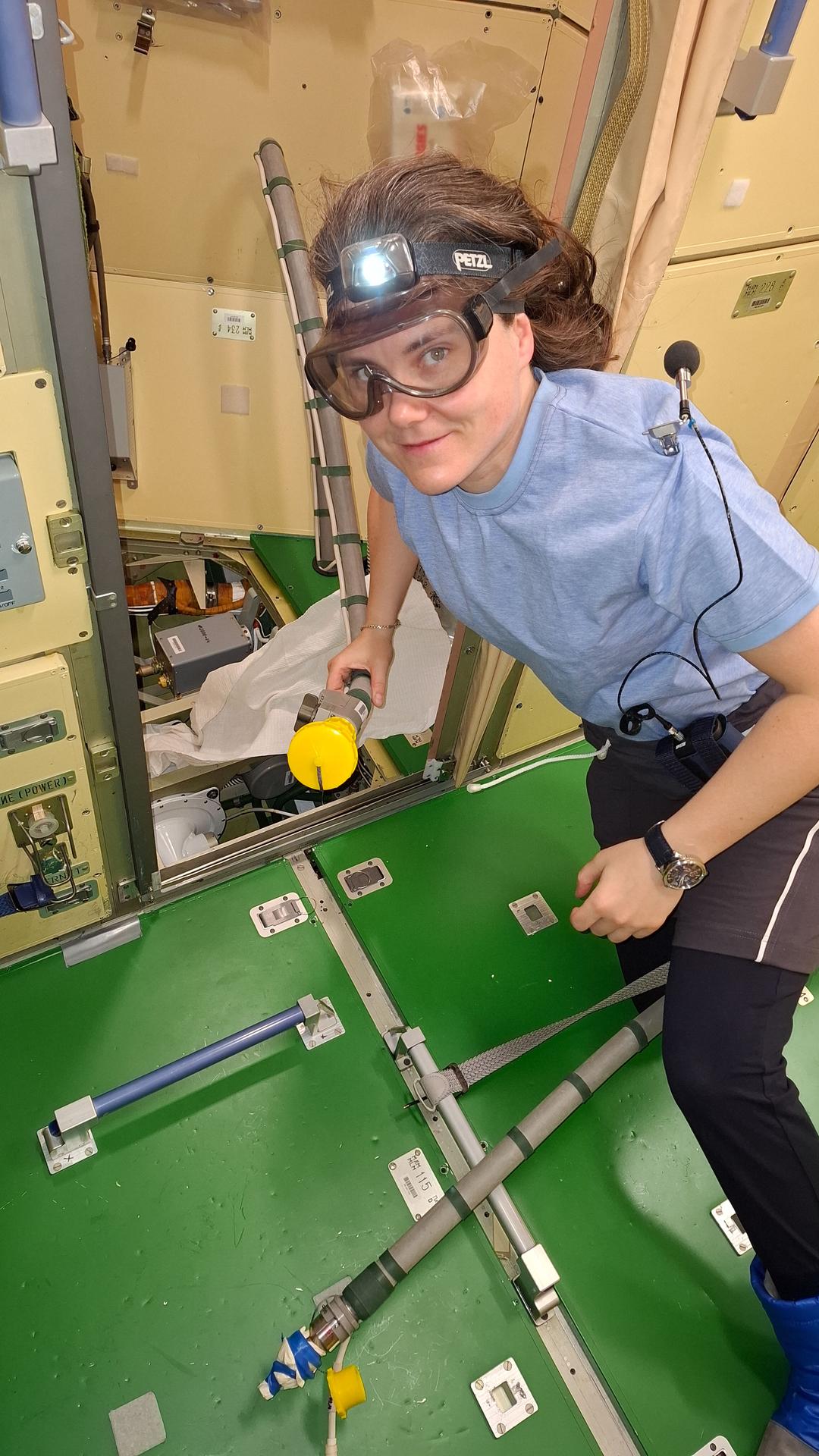 Roscosmos cosmonaut and Expedition 75 flight engineer Anna Kikina wears safety goggles while performing life support maintenance duties inside the International Space Station's Nauka science module.